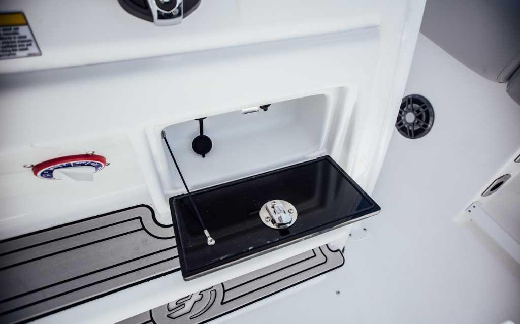 2021 Sea Fox 248 Commander boat interior detail with storage compartment and control panel.