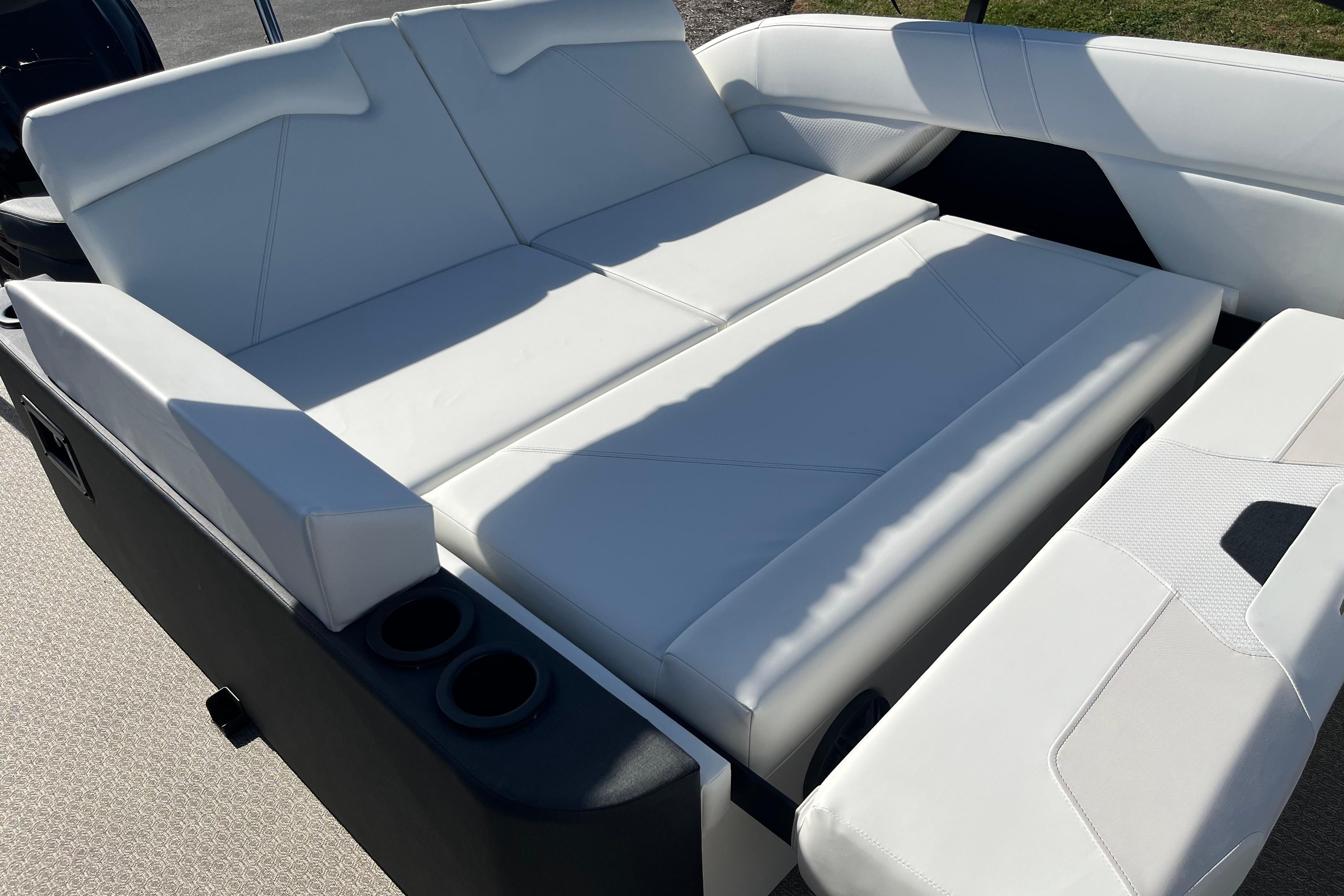 Luxurious white seating on 2026 Evotti 523CS boat, featuring cup holders and modern design.