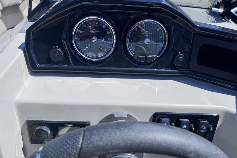 Dashboard of 2027 Manitou Aurora 23 RF SHP boat with gauges and controls.