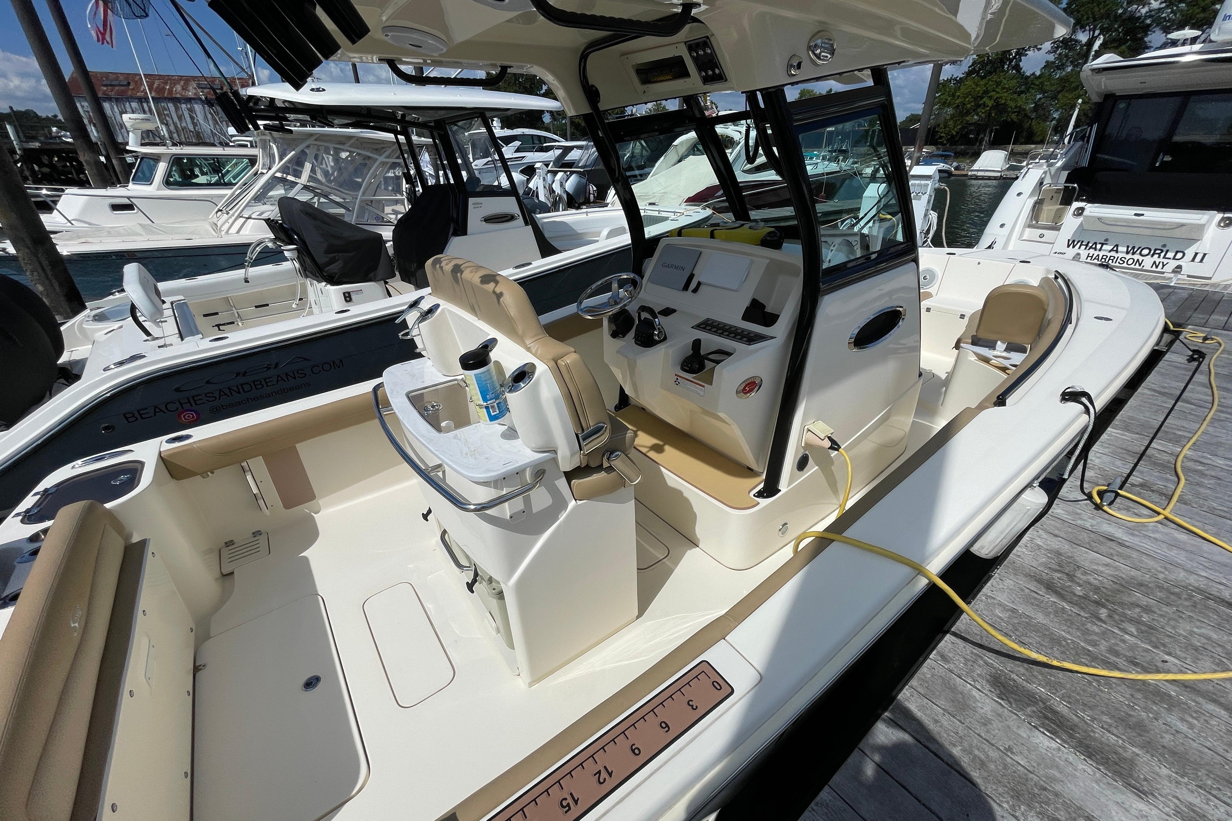 2020 Scout 255 LXF boat interior at marina, showcasing helm and seating area.