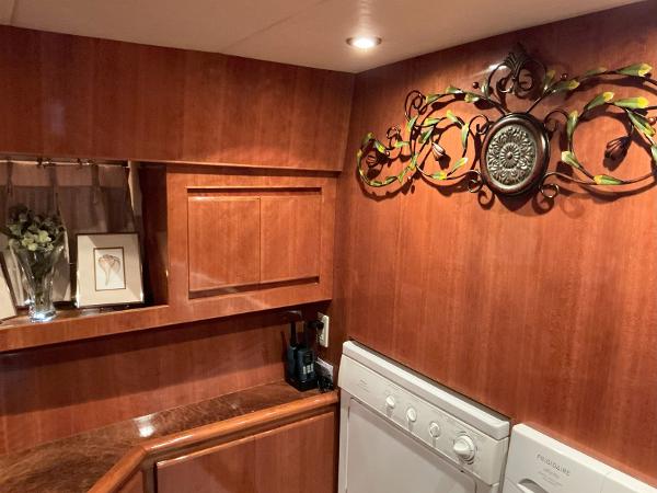 Luxurious wood-paneled interior of 2000 Novatec Islander 55 yacht with decorative wall art.