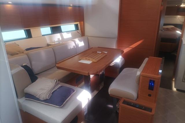 Interior of 2022 Hanse 460 yacht with modern seating and dining area.