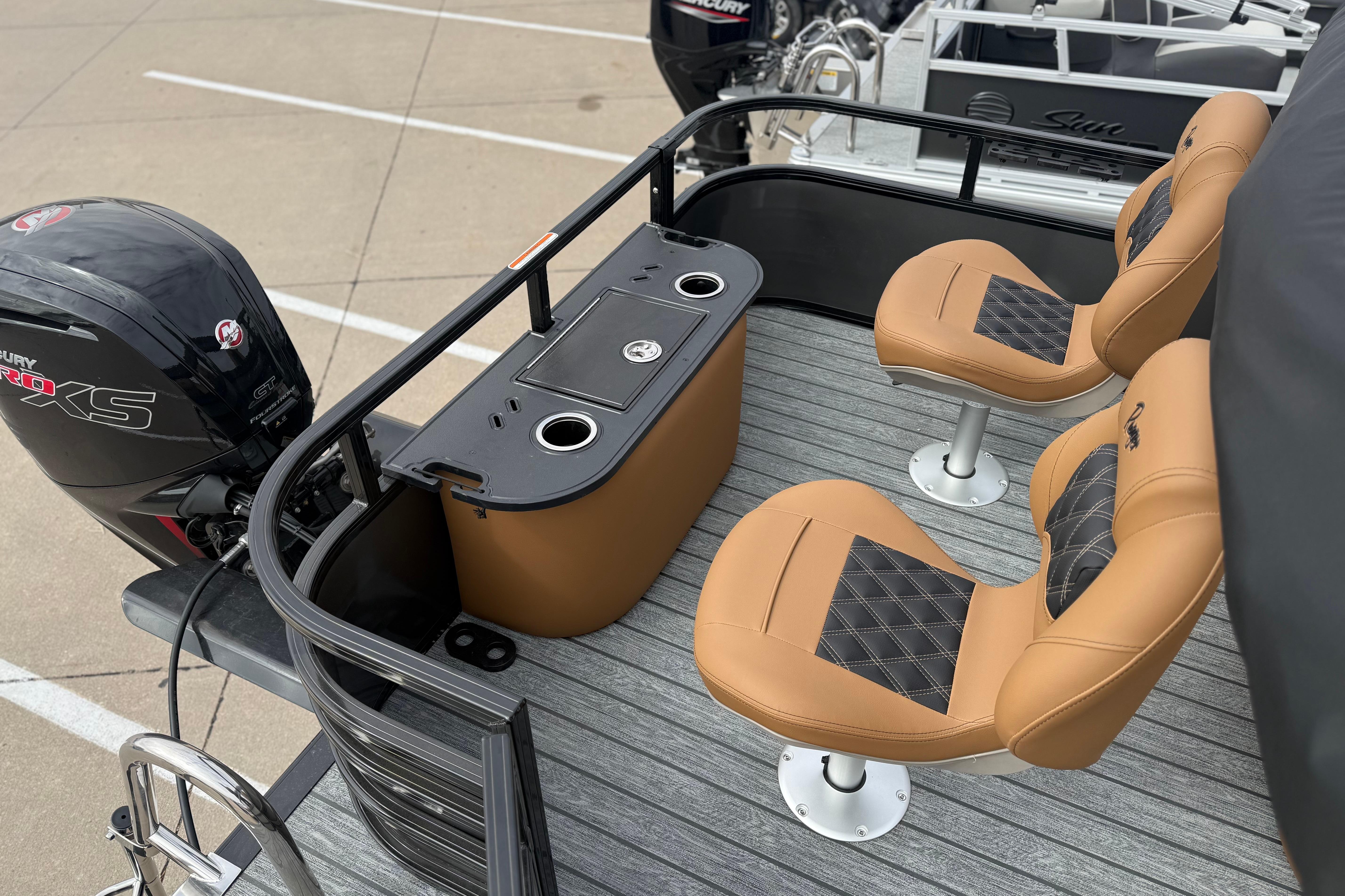 2026 Ranger 220F boat interior with tan seats and Mercury engine.