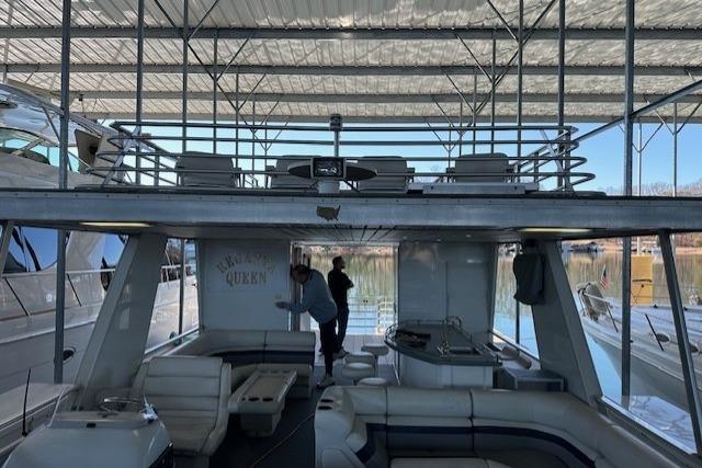 2008 Destination Yachts 45X14 houseboat with upper deck, docked in a marina.