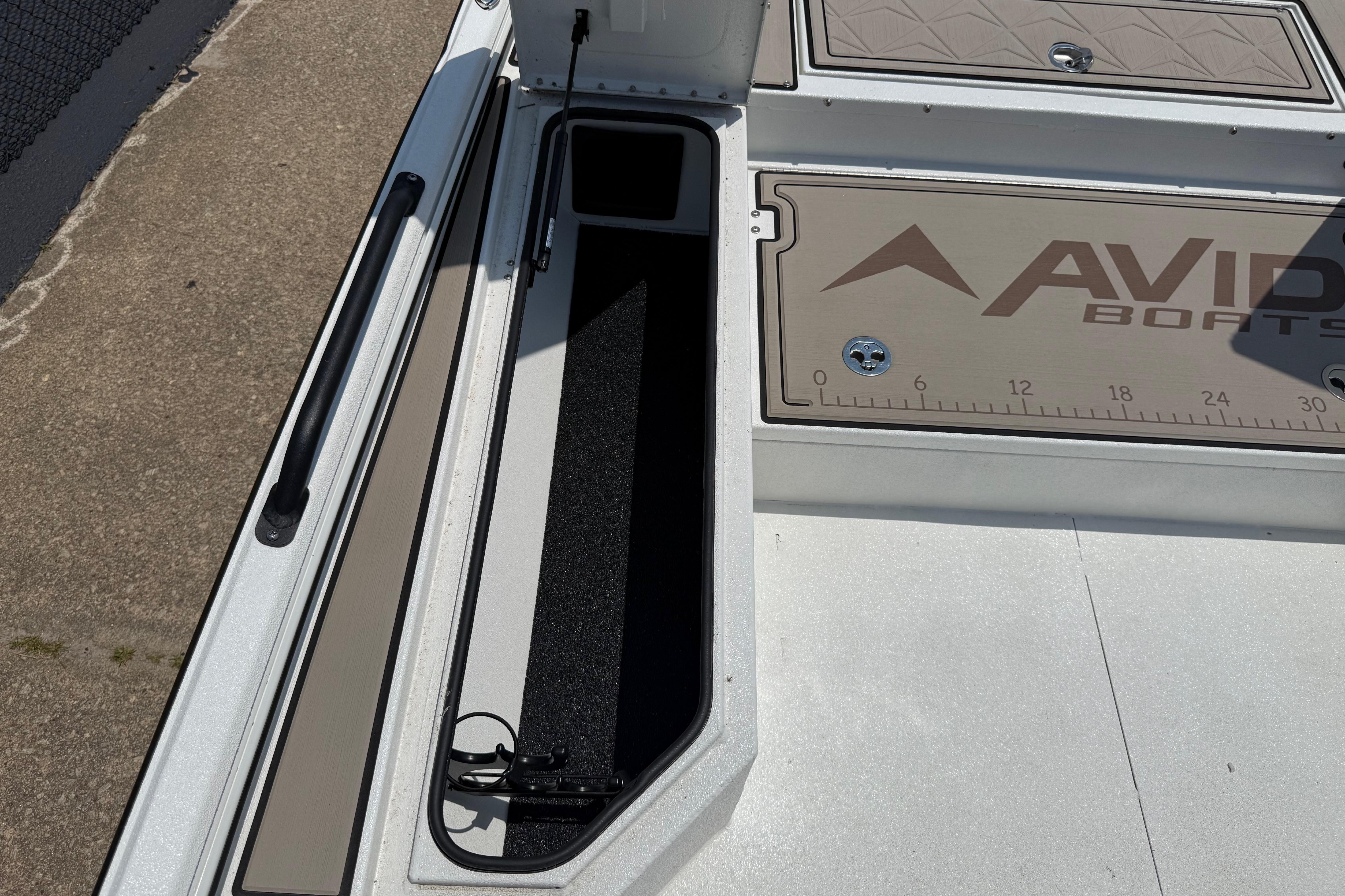 2025 Avid 22 Recon boat storage compartment with ruler and logo.