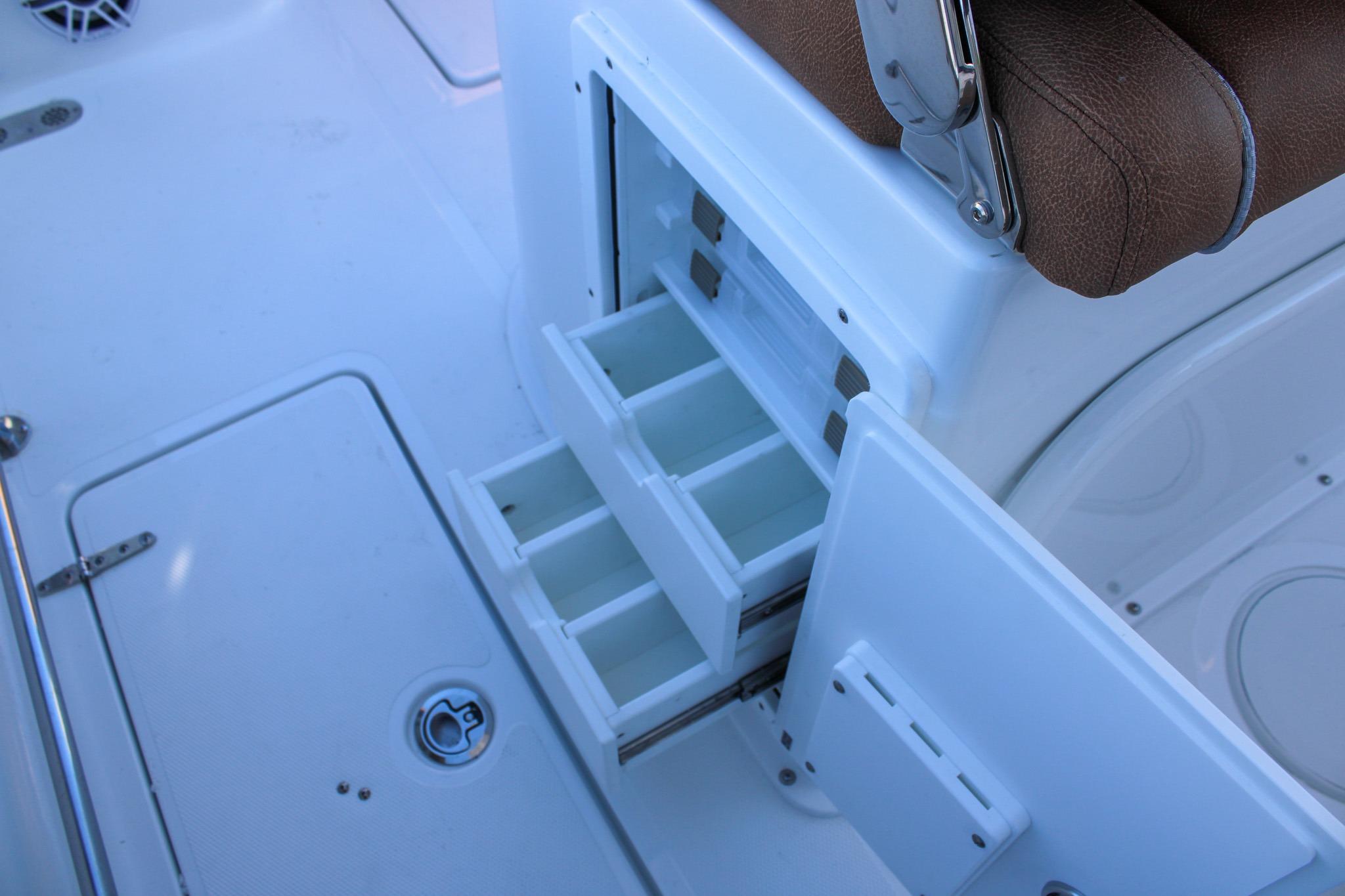 2026 Sea Hunt Gamefish 25 boat with open tackle storage drawers.