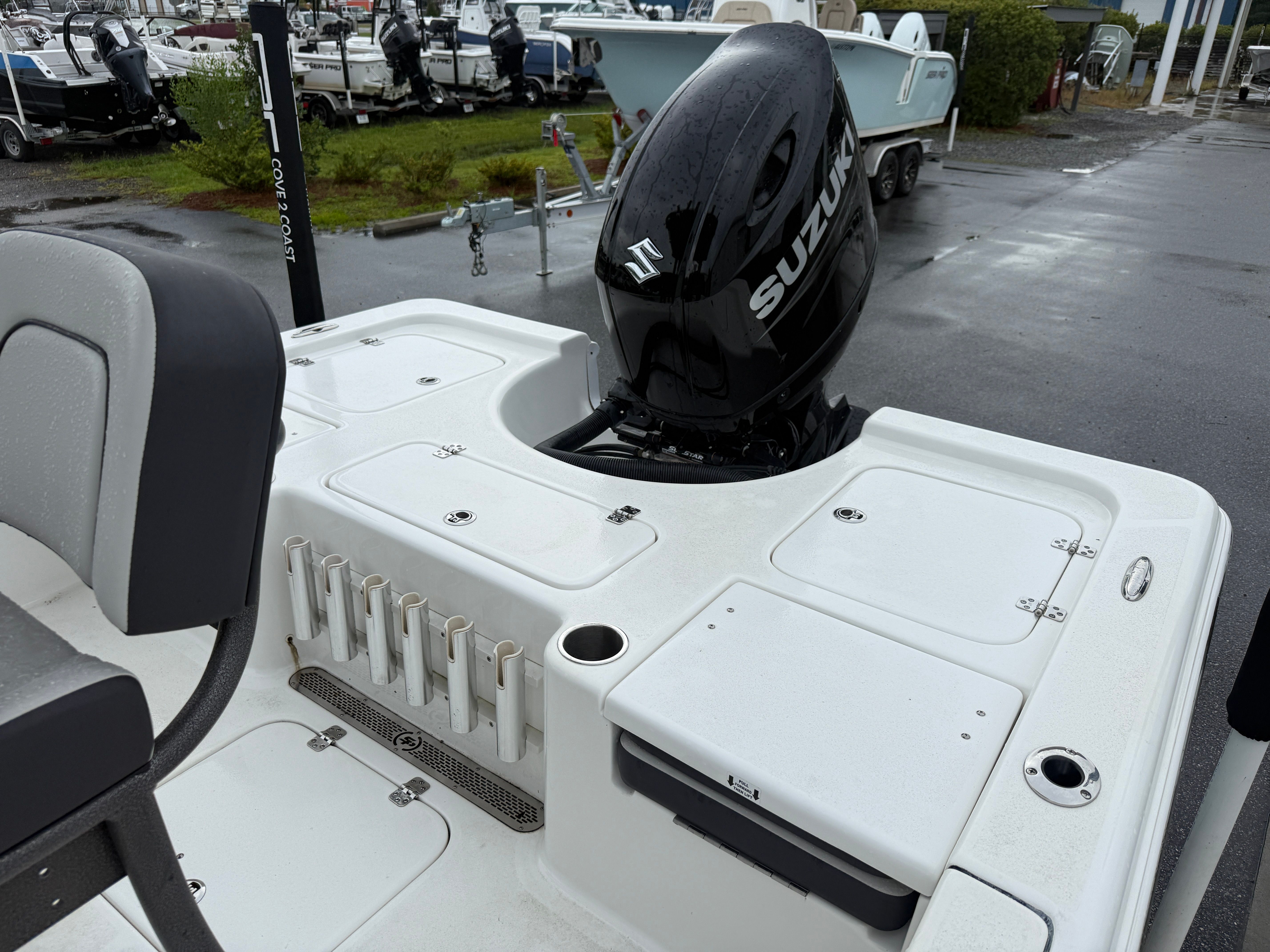 The image shows the stern of a Sea Pro 230 DLX boat with a Suzuki outboard motor.