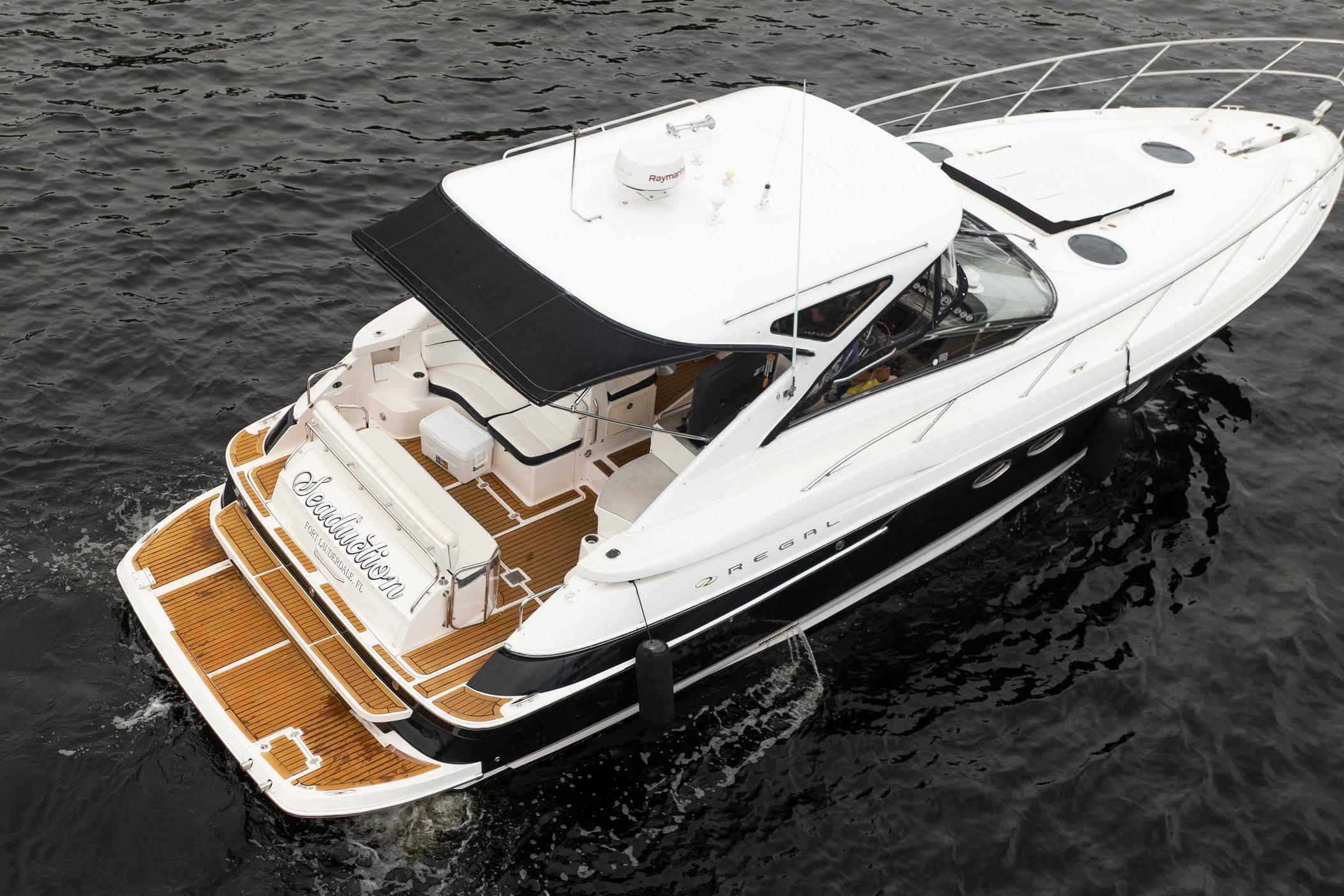 2008 Regal Commodore 4460 yacht on water, featuring sleek design and spacious deck.