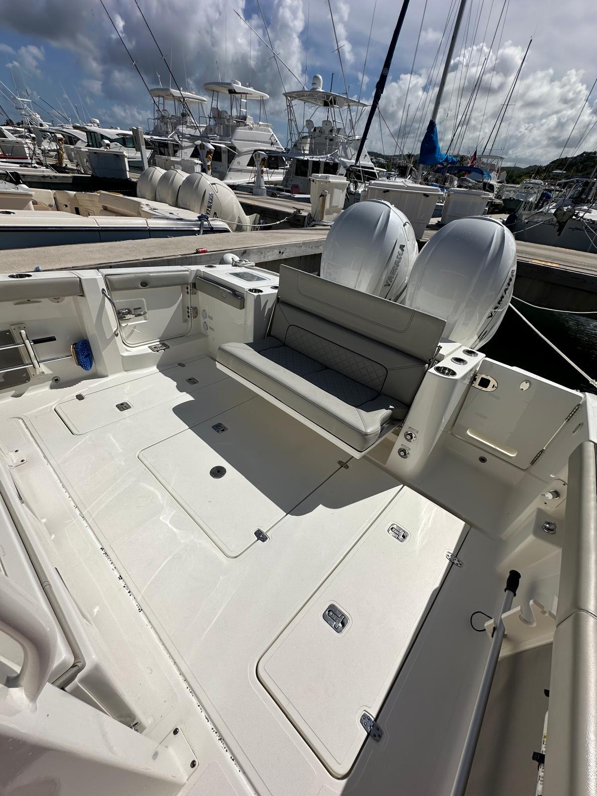 2023 Pursuit S 358 Sport boat with dual engines docked at marina.