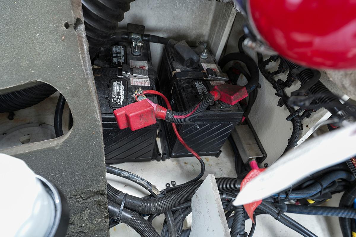 Battery compartment of a 2018 Sea Ray SLX 350 boat, featuring wiring and connections.