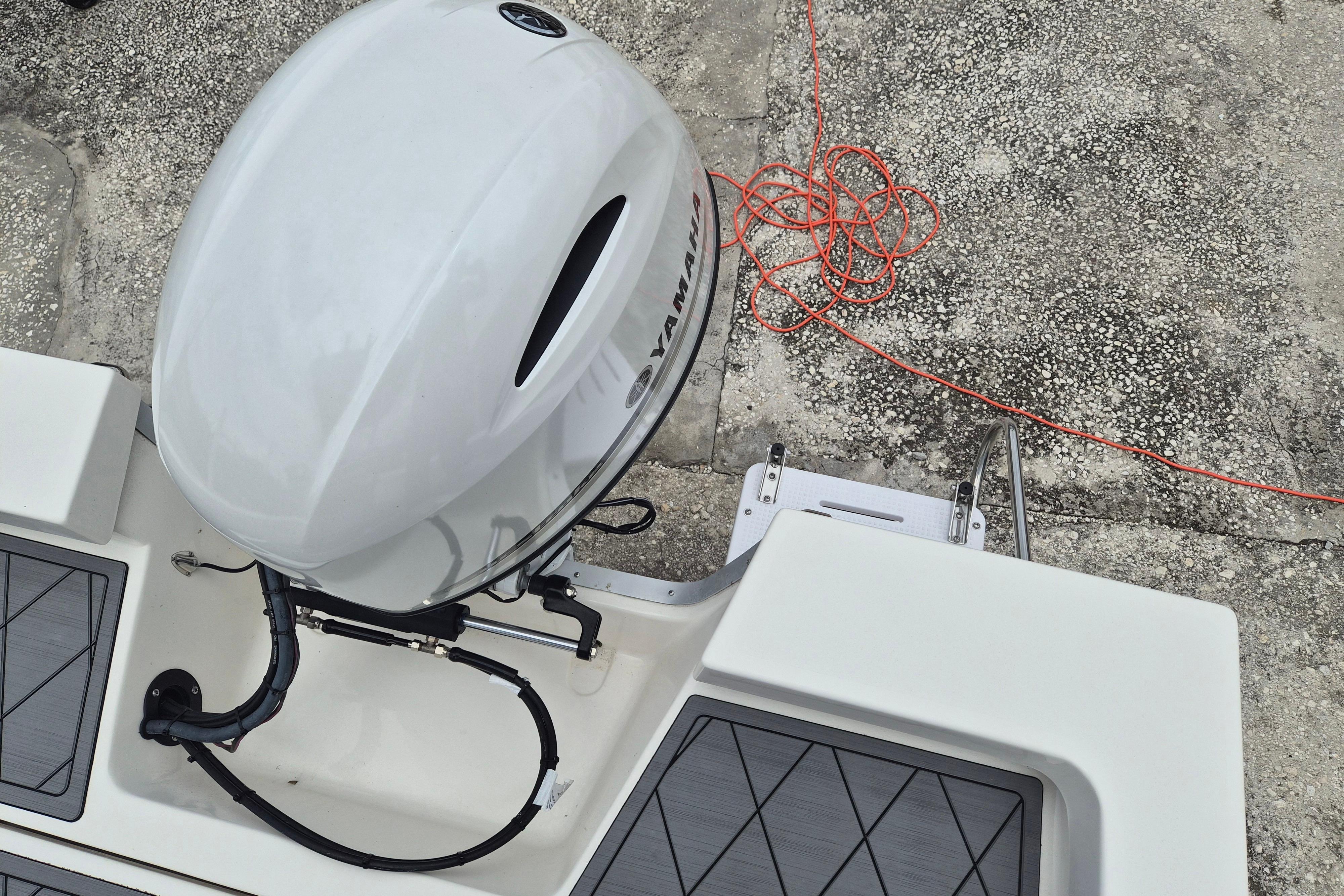2026 Defiance Catalina 190 boat with Yamaha outboard motor, docked on textured surface.