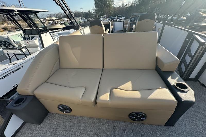 Luxurious beige seating on 2026 Evotti 523CS boat, featuring cup holders and speakers.
