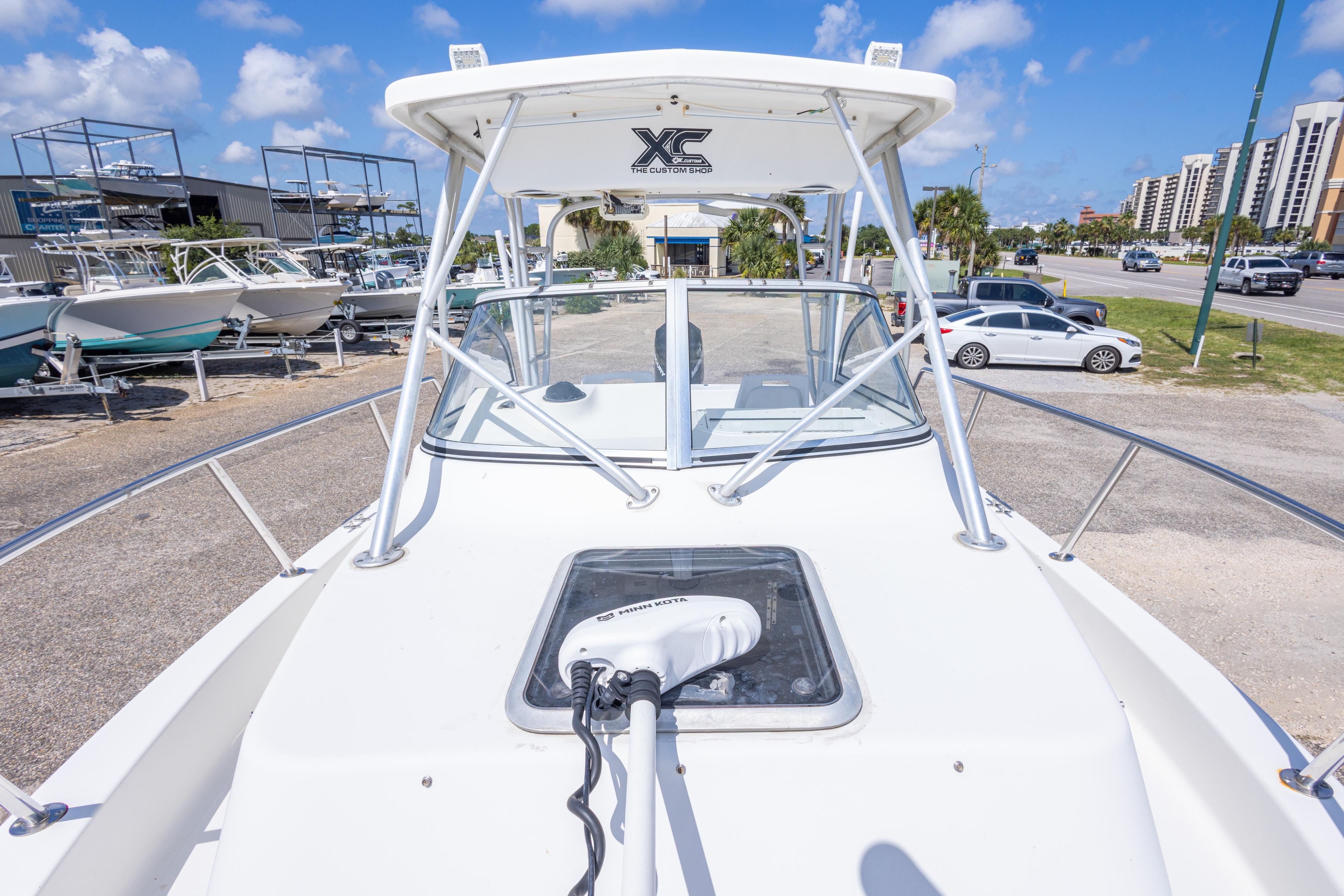 2007 Sea Boss 235 Walkaround boat on display in a sunny marina setting.