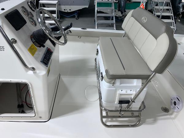2024 Key West 188 Bay Reef boat interior with steering console and cushioned seating.