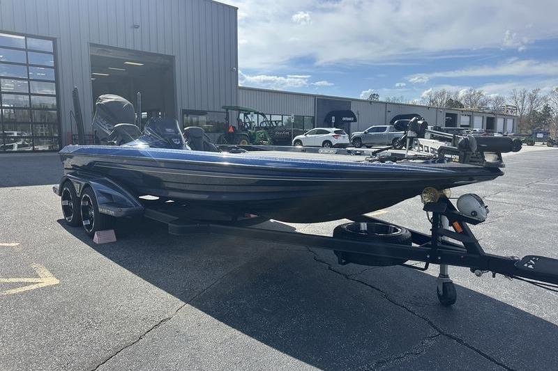 2020 Skeeter FXR21 boat on trailer outside dealership under cloudy sky.