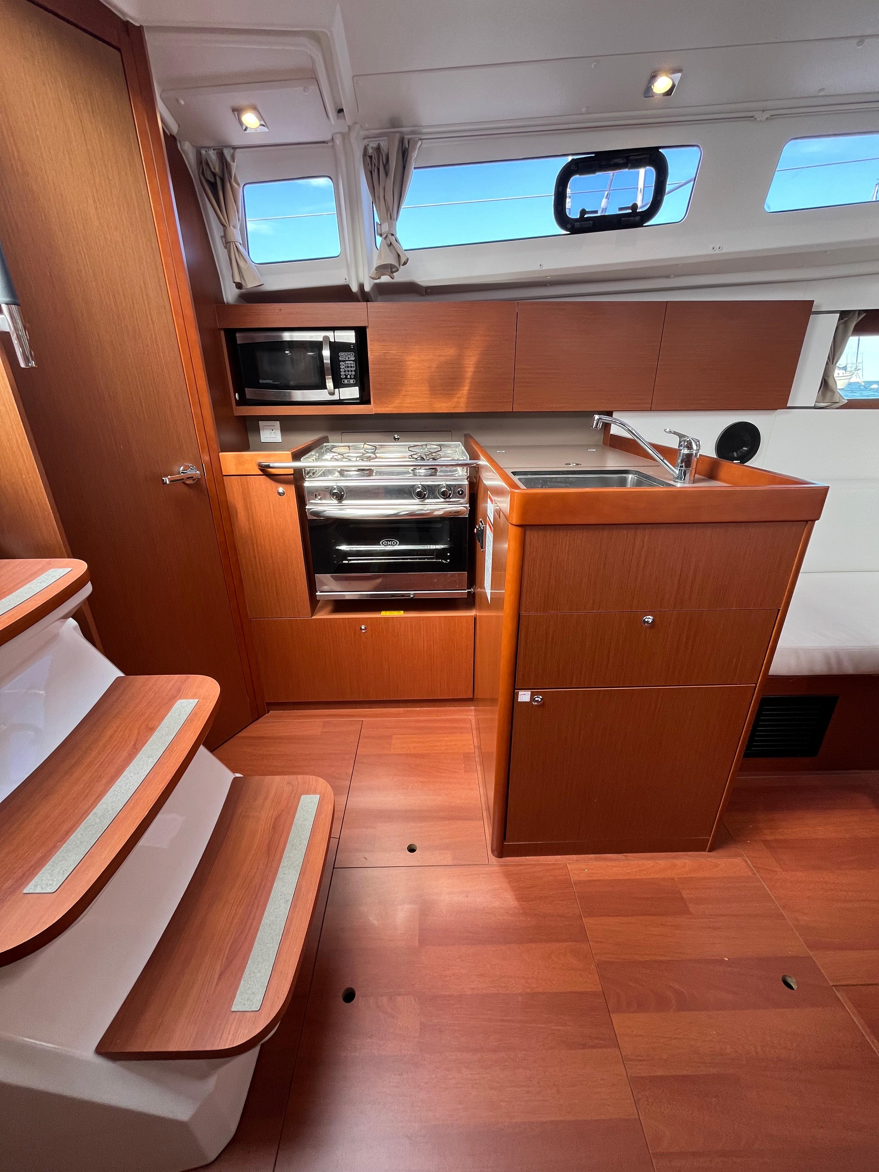 2018 Beneteau Oceanis 35.1 yacht interior with modern kitchen and wooden flooring.