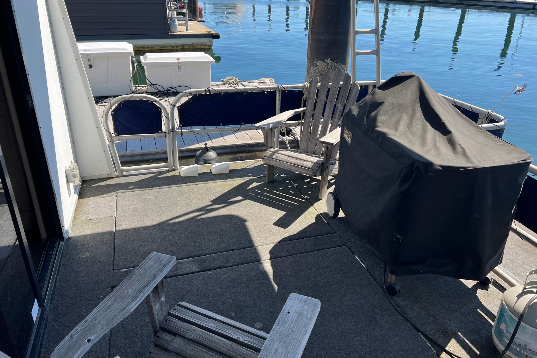 Deck of a 1993 Sumerset houseboat with chairs and a covered grill.