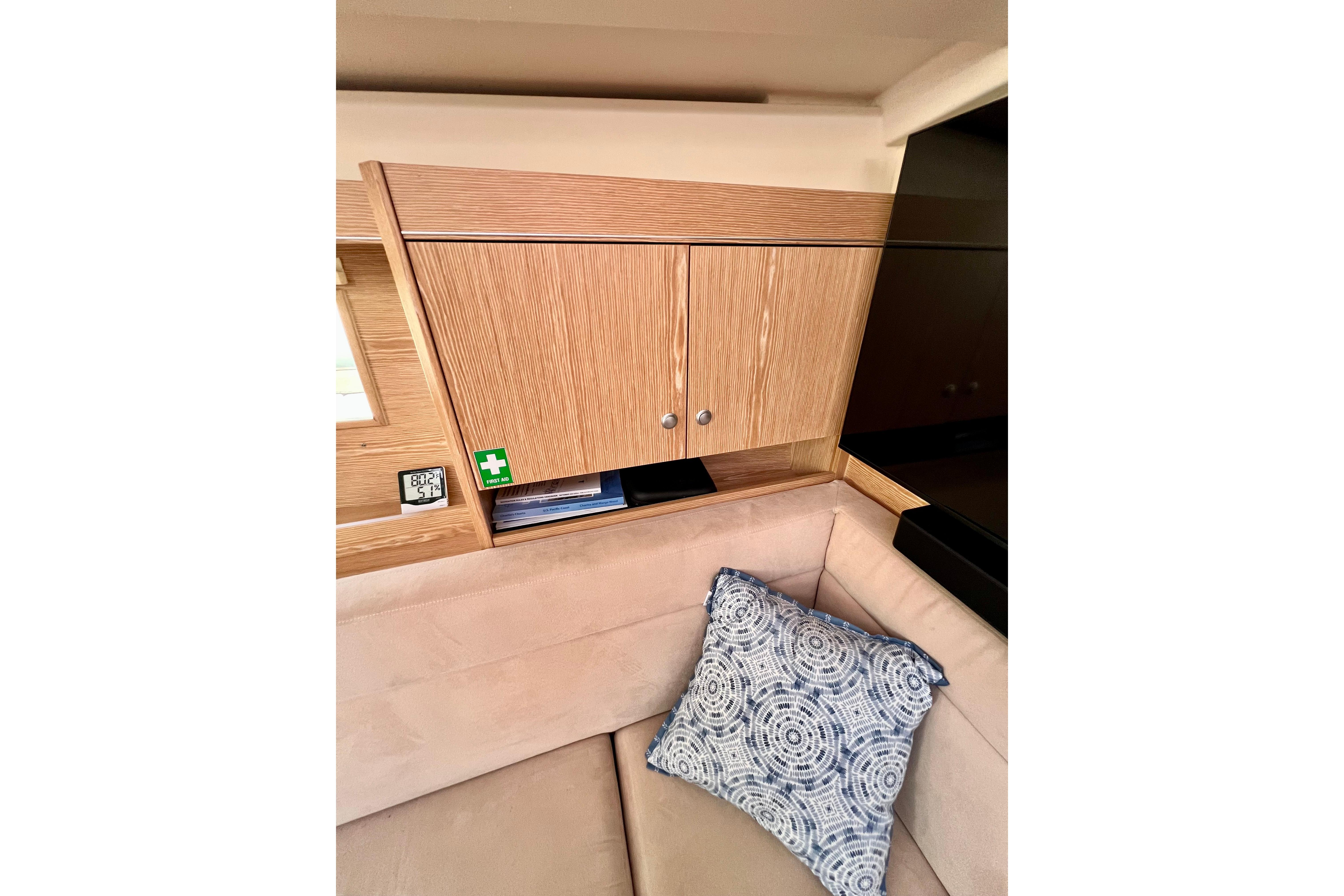 Interior of 2016 Hanse 455 yacht with wooden cabinetry and patterned cushion.