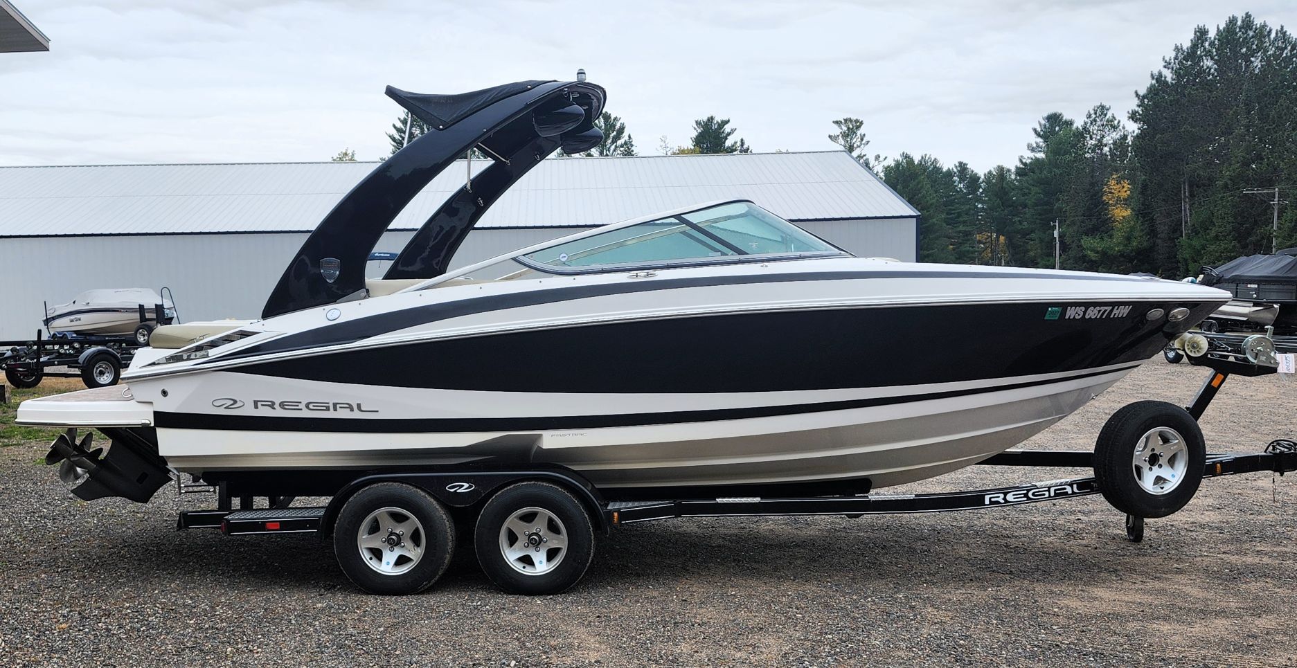 2011 Regal 2300 on a trailer, featuring a sleek design and black paint.