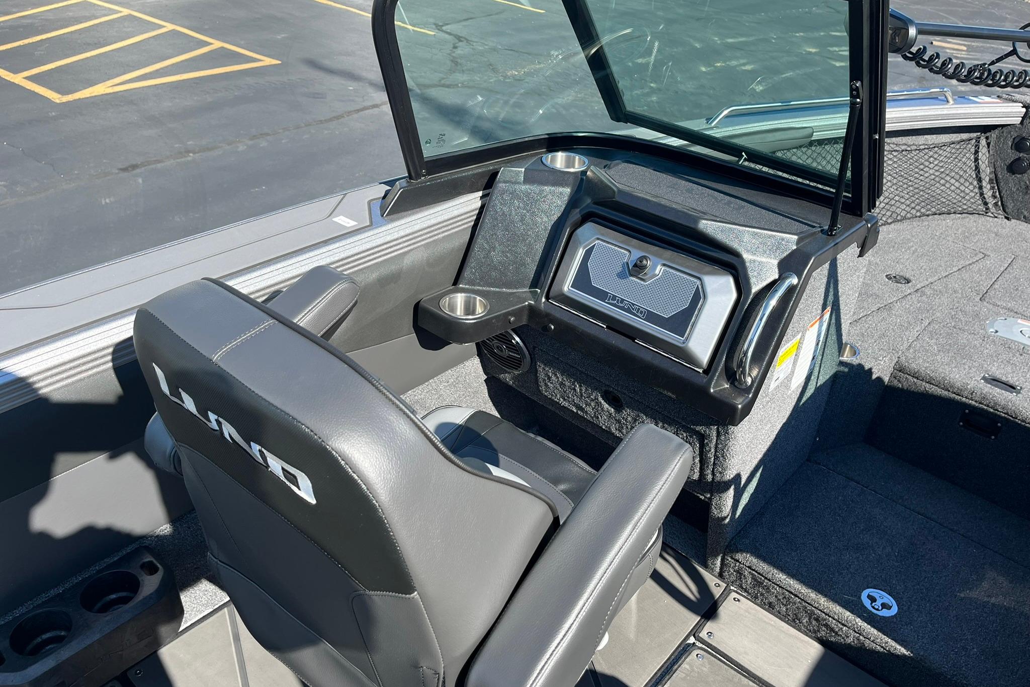 2026 Lund 2275 Baron boat interior with steering console and seating.