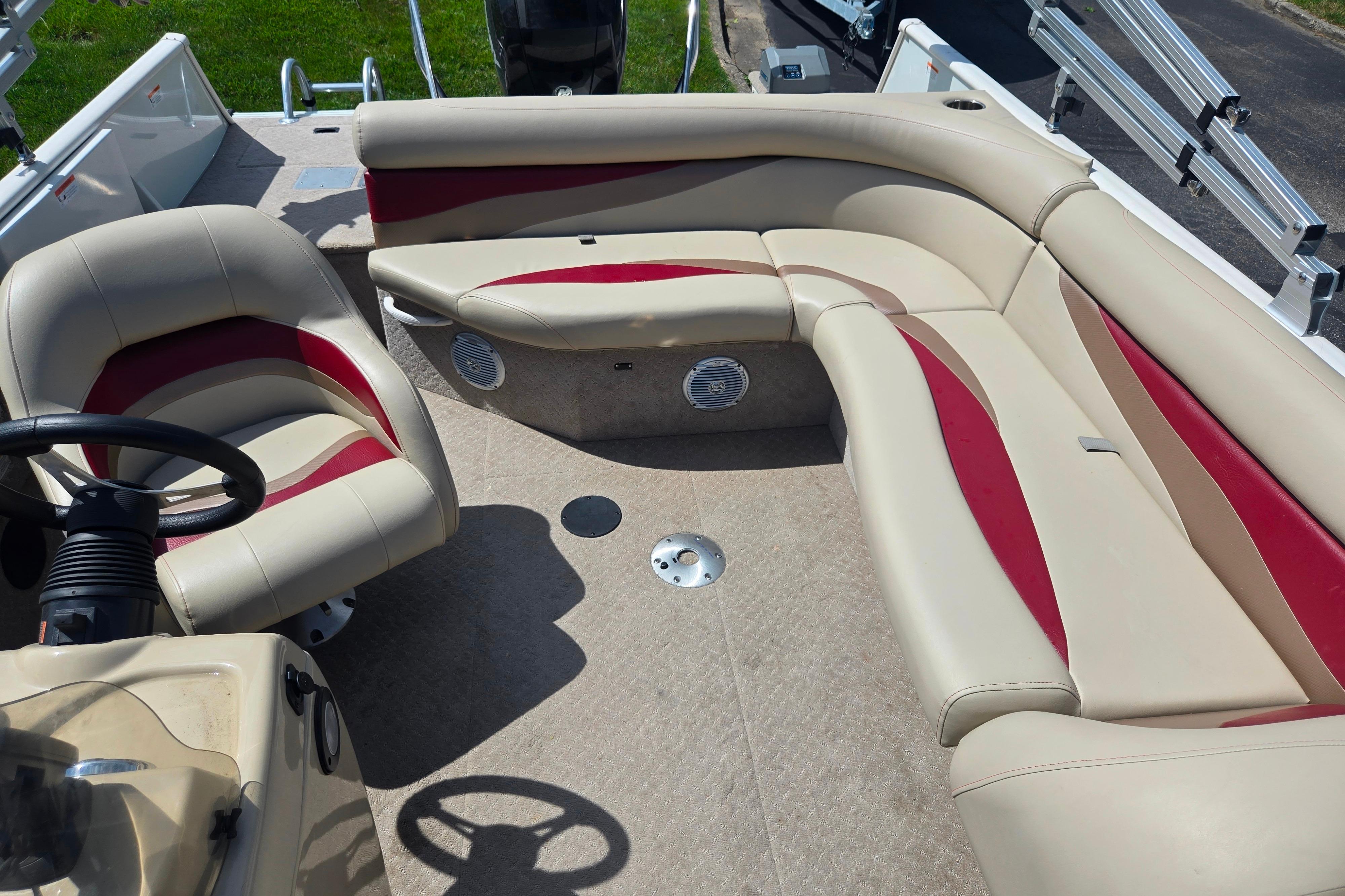 2015 Lowe Sport Deck 224 boat interior with beige and red seating.