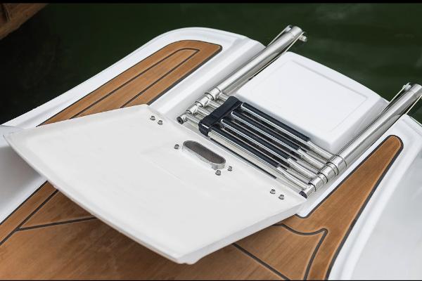 Manufacturer Provided Image: 2026 Hurricane SunDeck 2690 OB swim platform with retractable ladder and teak-style finish.