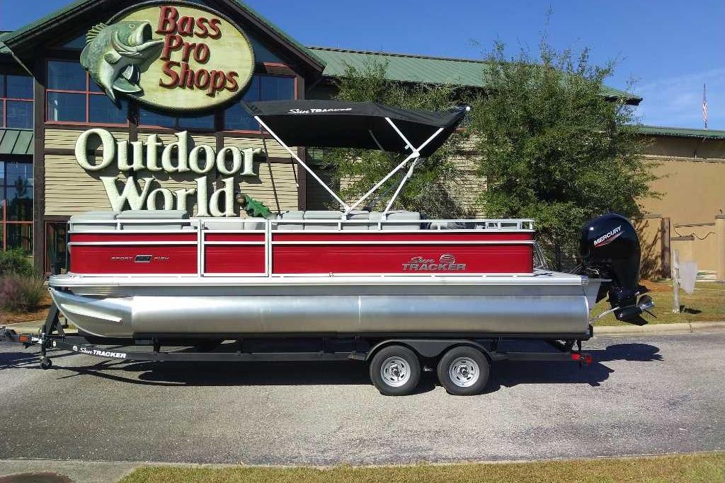2026 Sun Tracker SportFish 22 DLX pontoon boat displayed at Bass Pro Shops Outdoor World.