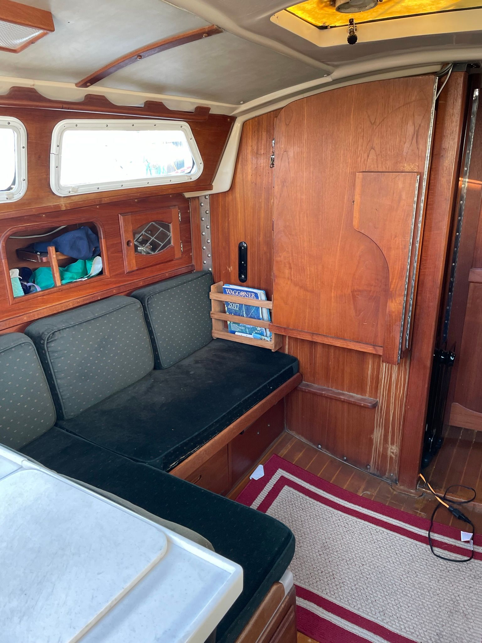 Interior of a 1982 Newport 33 with wooden walls and cushioned seating.