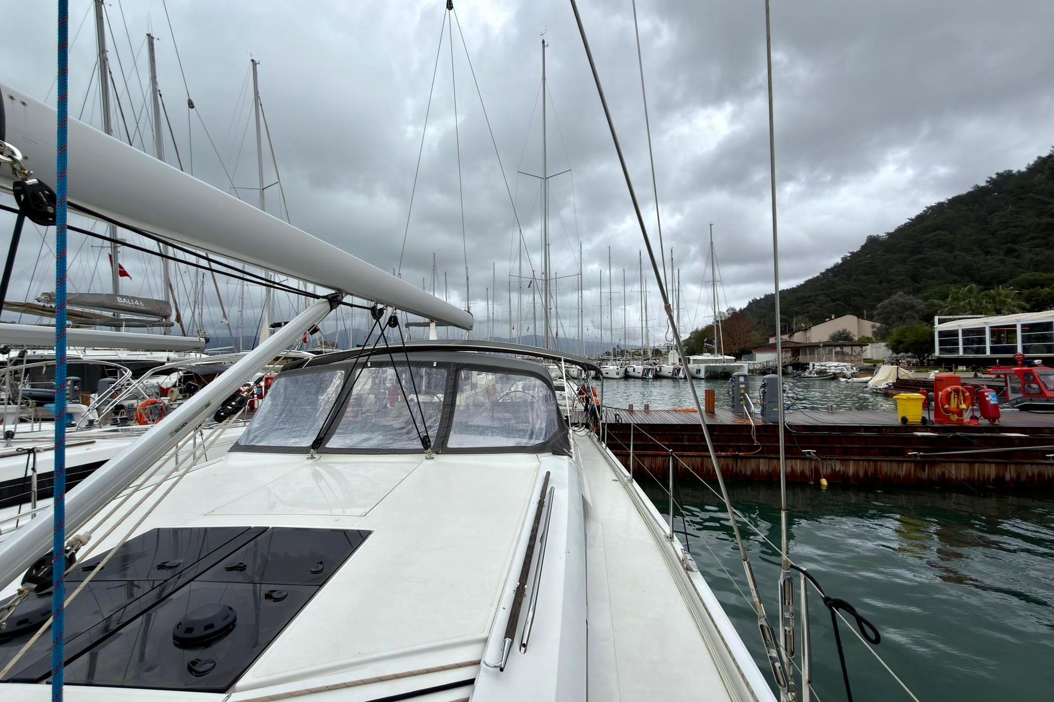 2024 Hanse 510 yacht docked at marina under cloudy skies.
