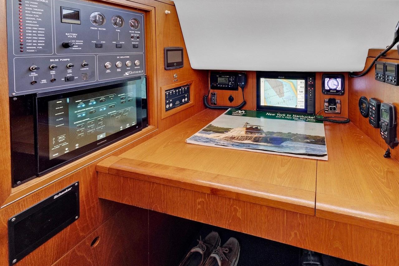 Navigation station of 2011 Southerly 57 RS yacht with control panels and map.