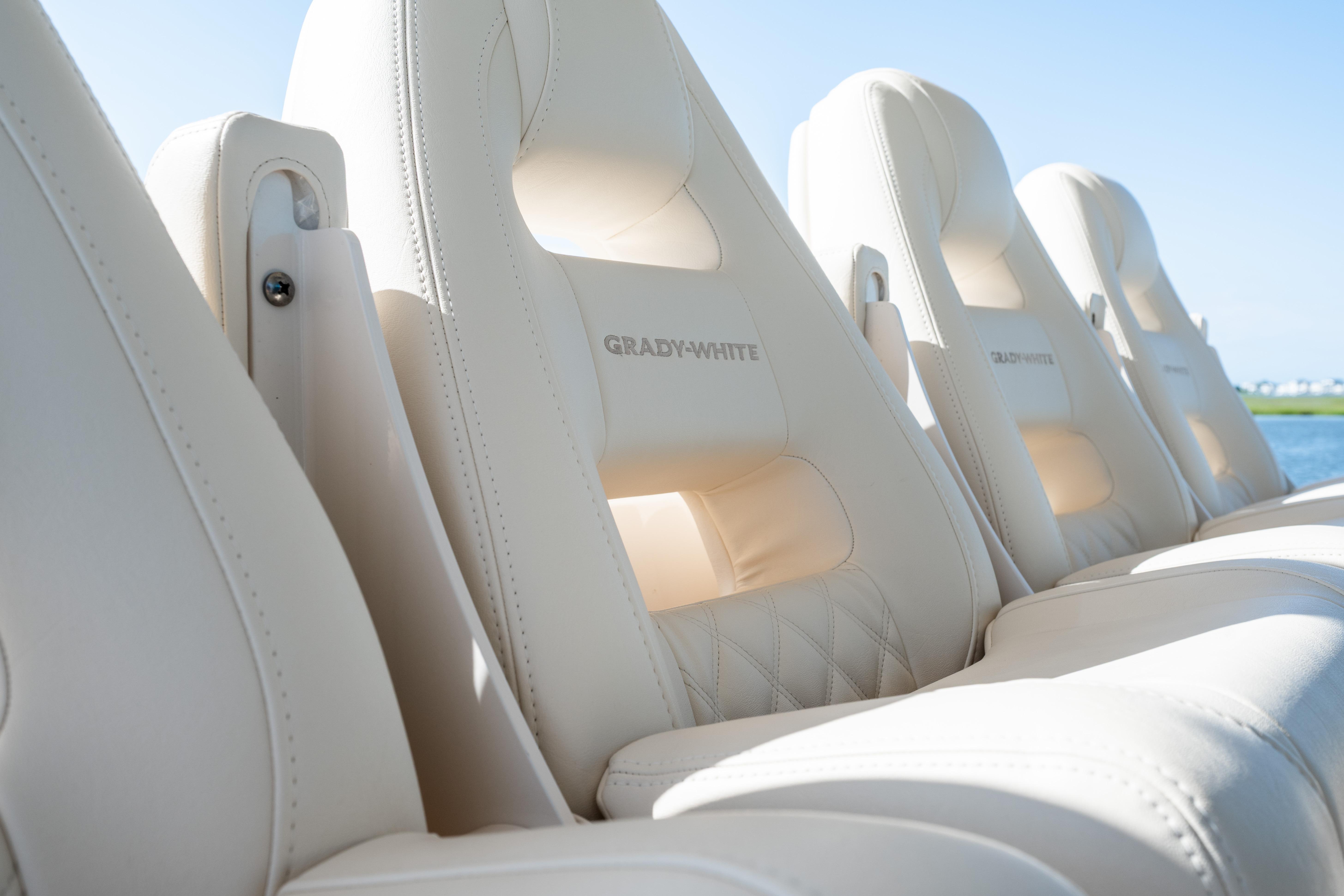 Luxurious seating on the 2025 Grady-White Canyon 386 boat, featuring elegant white upholstery.