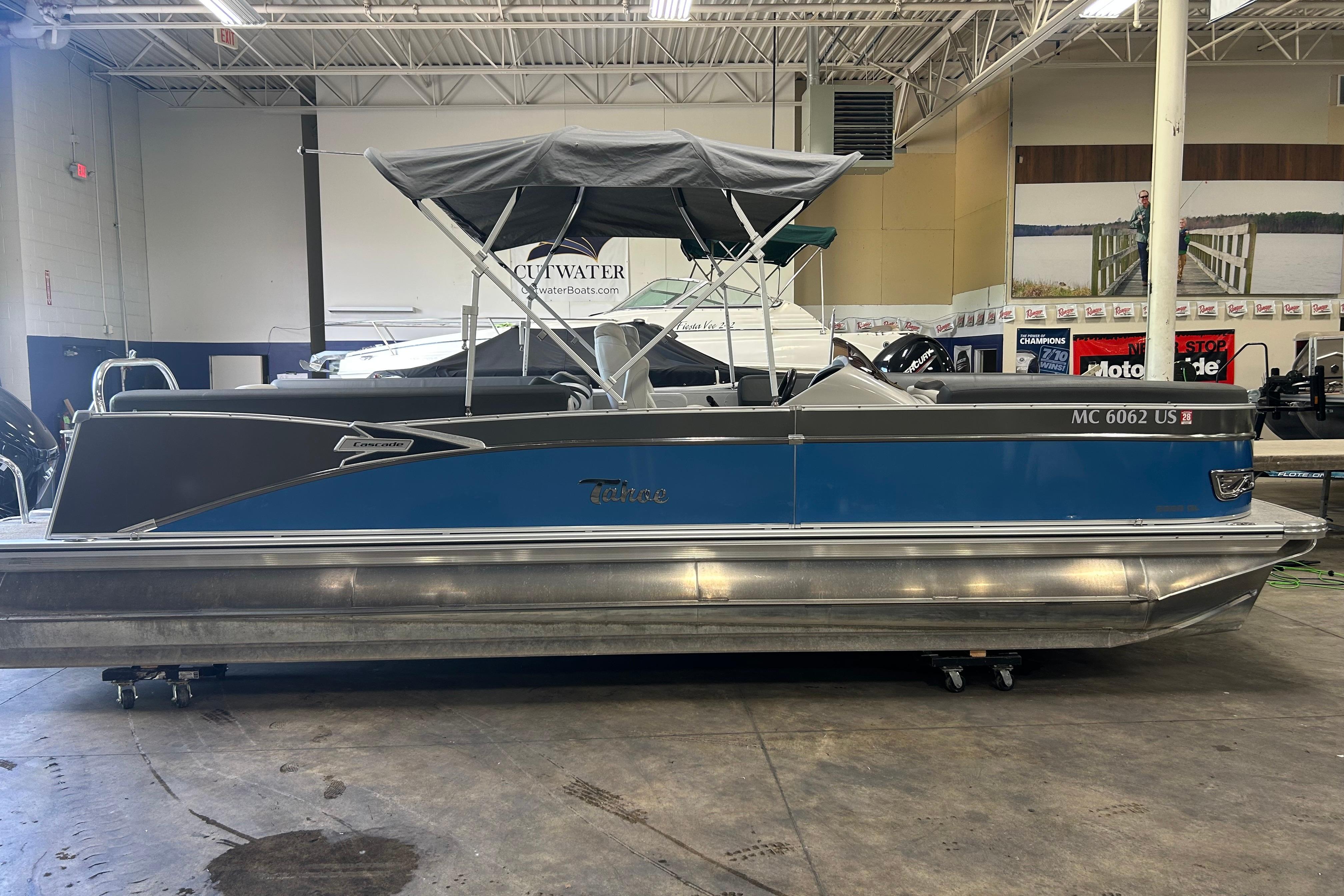 2022 Tahoe Pontoon Cascade Quad Lounger in showroom, blue and silver design.