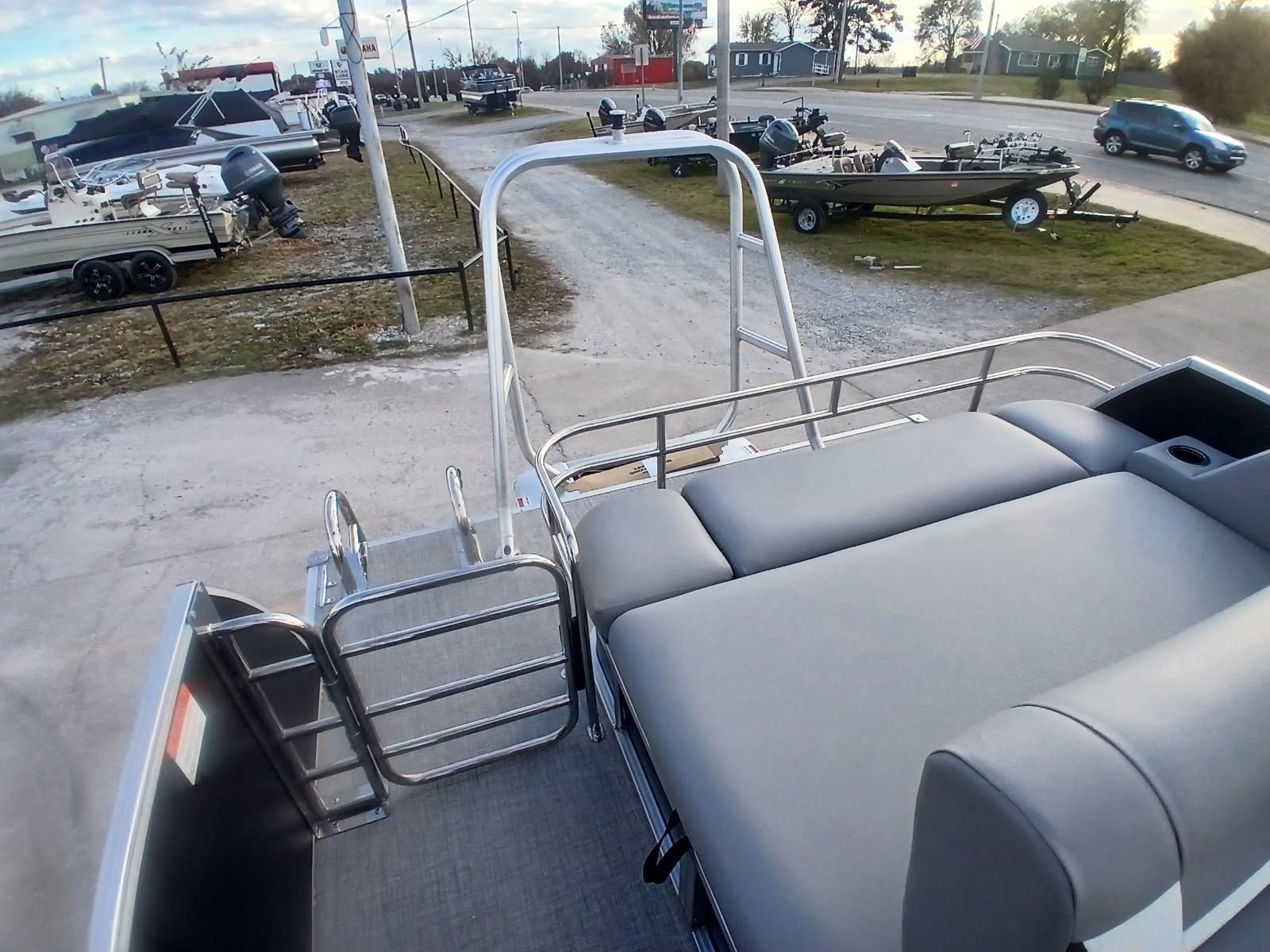 Landau 23 Island Breeze 2026 pontoon boat in a parking area.
