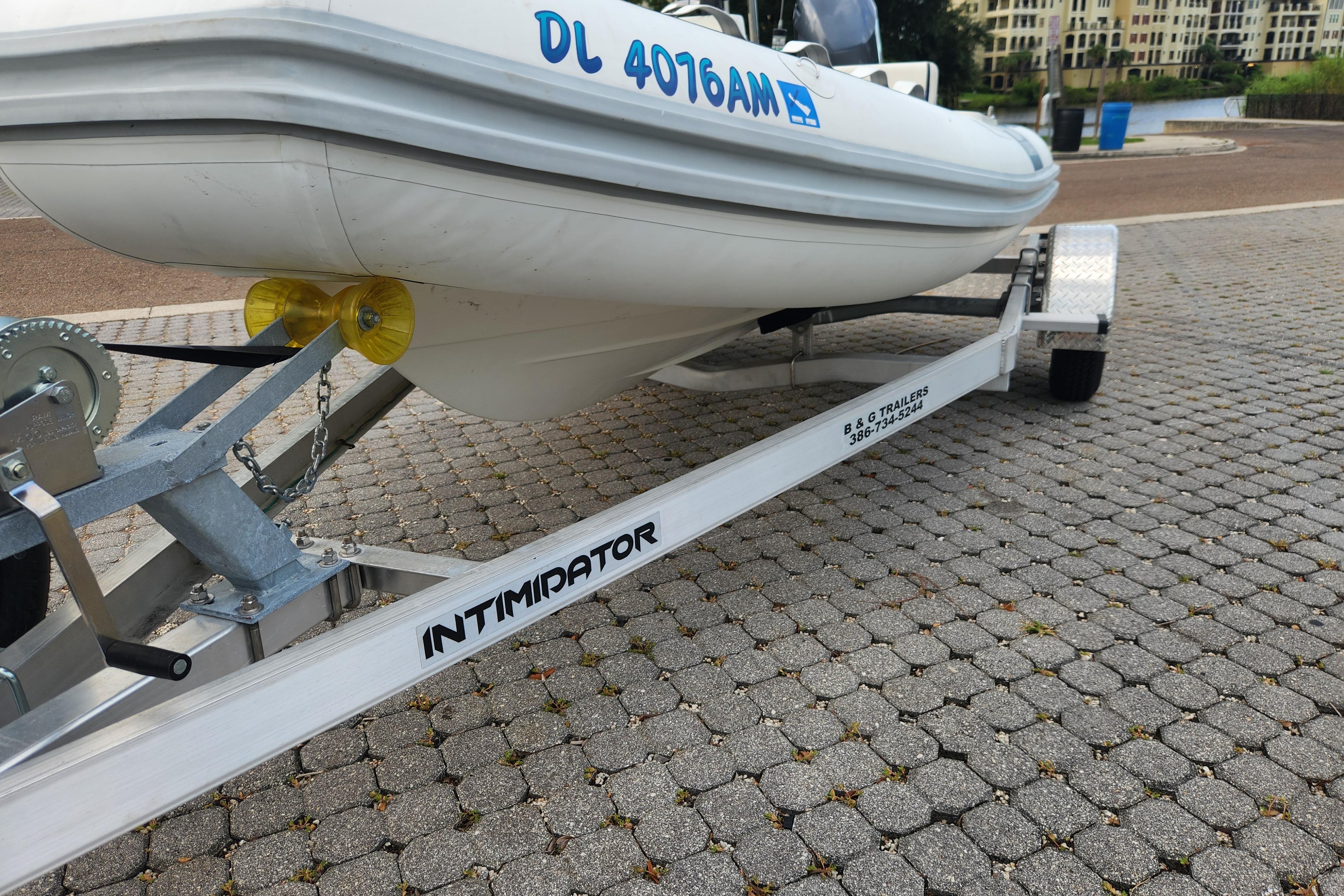 2019 Novurania DL 400 boat on Intimidator trailer, parked on cobblestone surface.