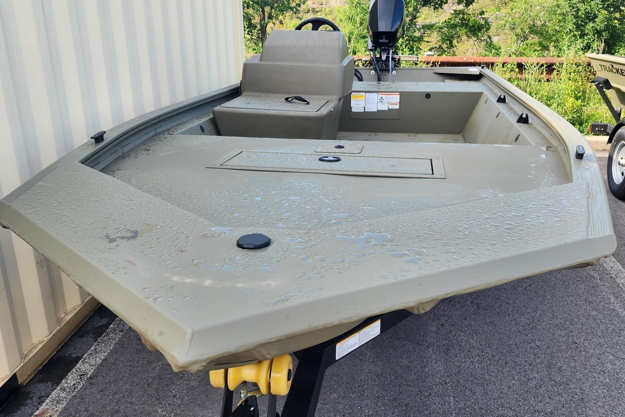 2026 Tracker Grizzly 1648 SC boat with wet deck, parked outdoors.