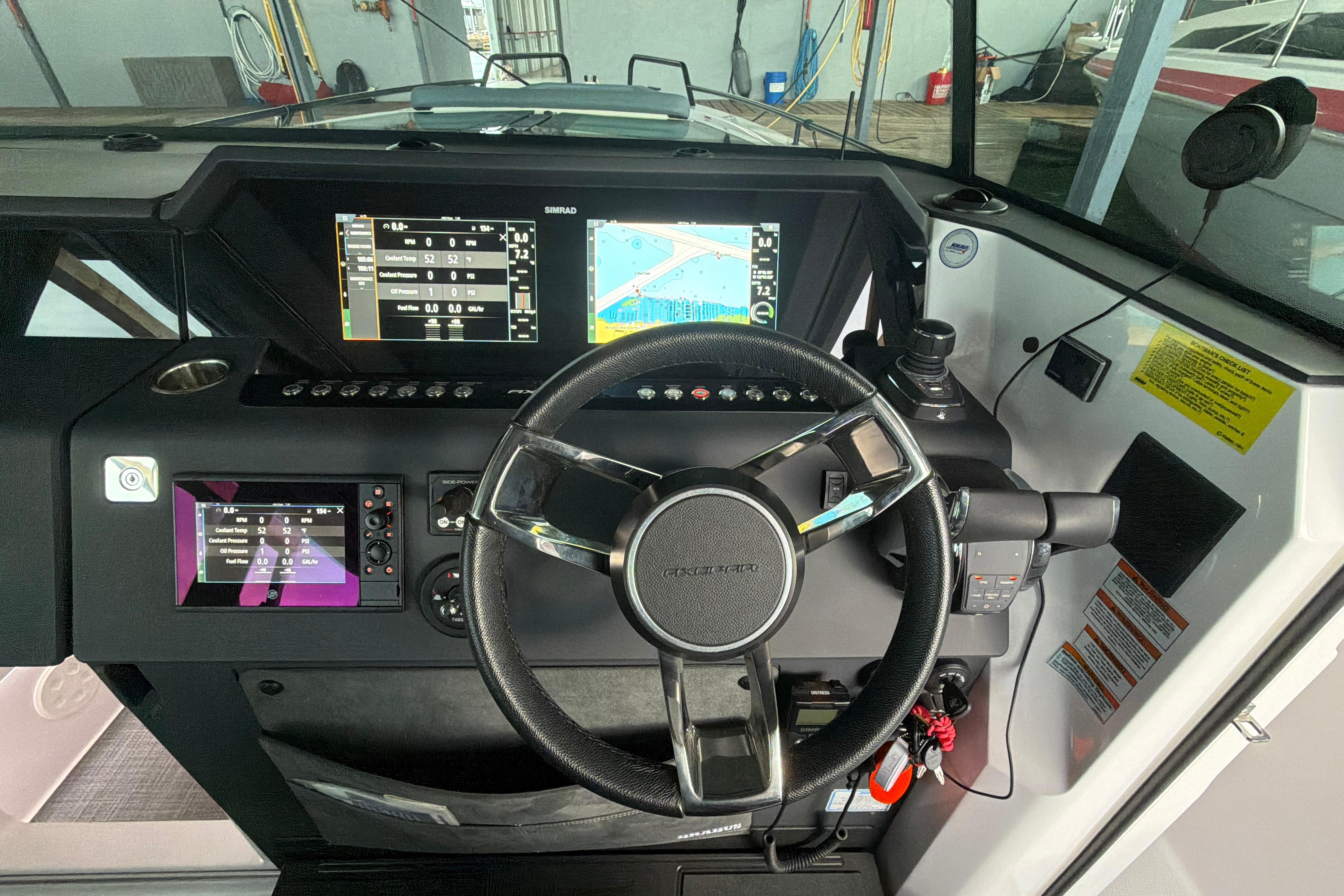 2022 Axopar Brabus 37 XC Cross Cabin dashboard with steering wheel and navigation screens.