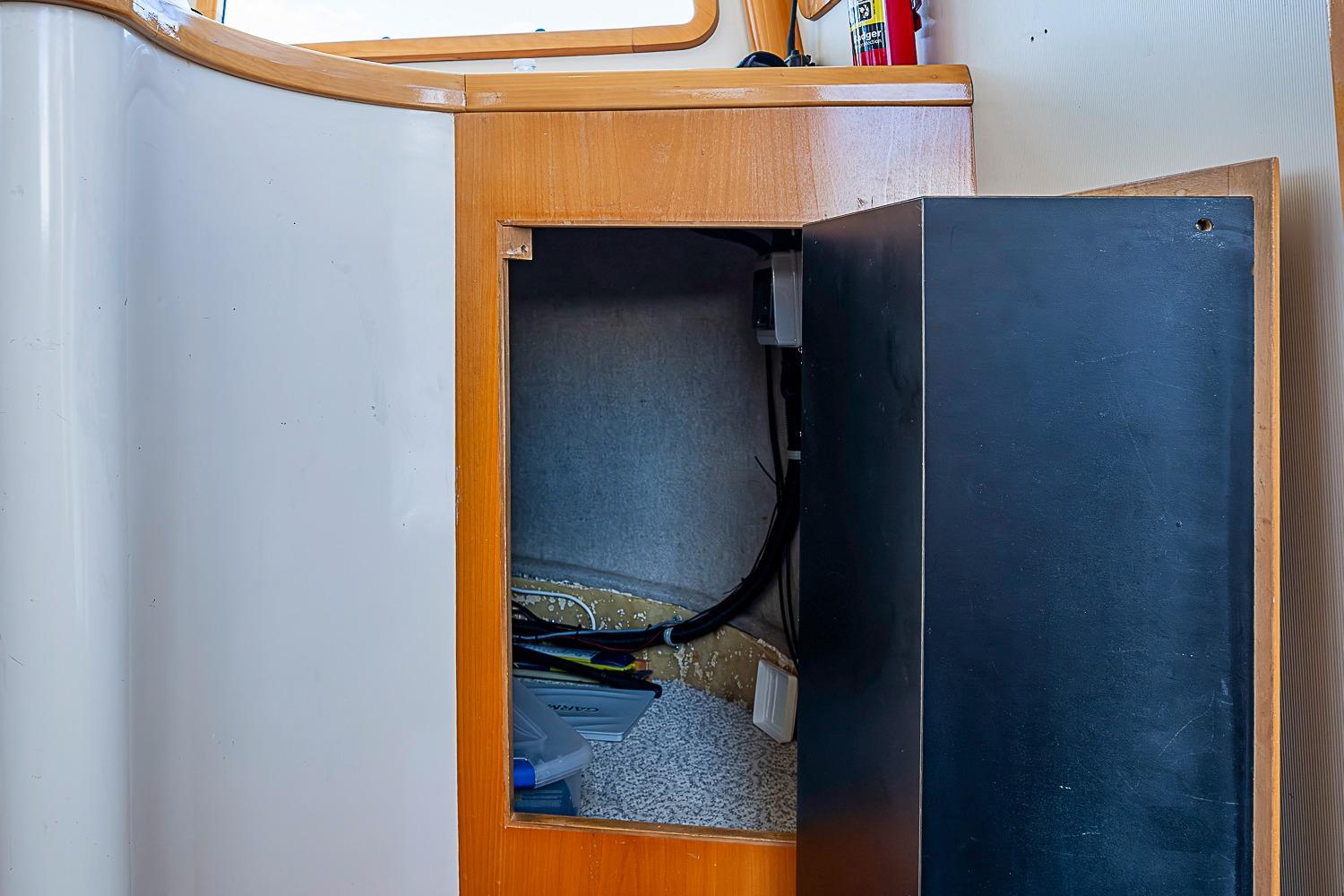 Open cabinet on 2003 Magna Marine Nova Scotia 47 boat, revealing interior storage space.