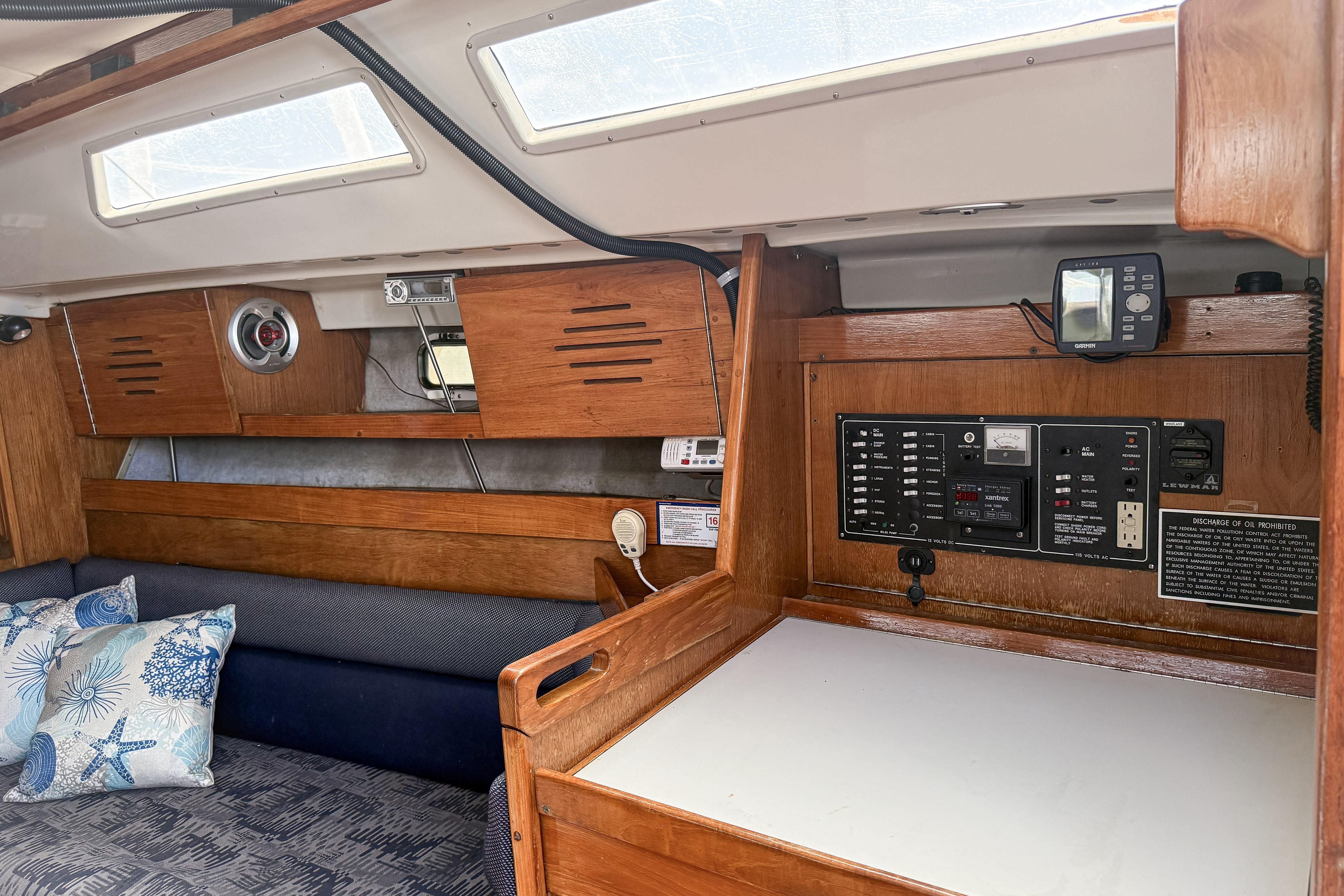 Interior of a 1988 Oday 40 sailboat featuring a control panel and seating area.