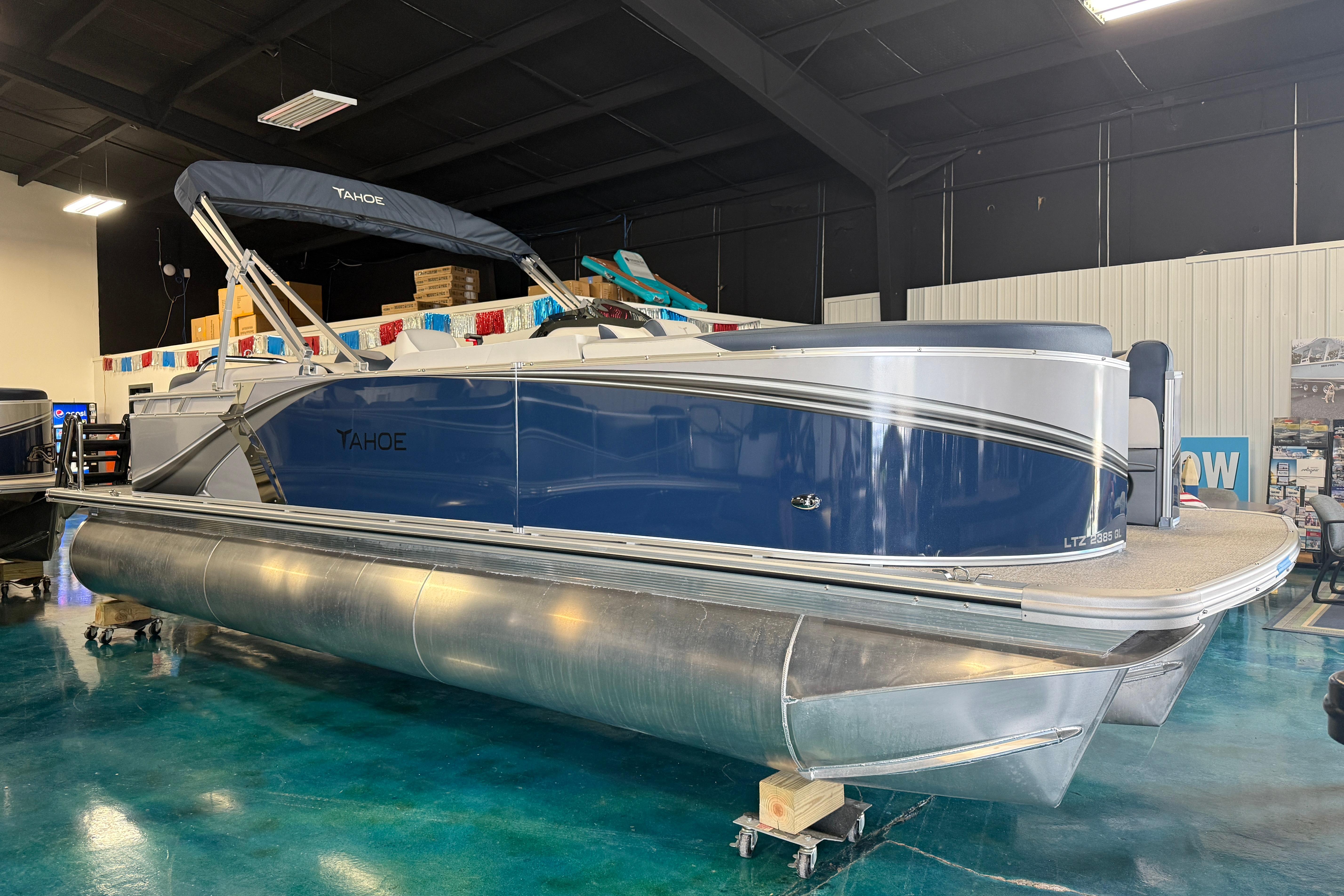 2026 Tahoe Pontoon LTZ Quad Lounger in showroom, featuring sleek design and modern amenities.