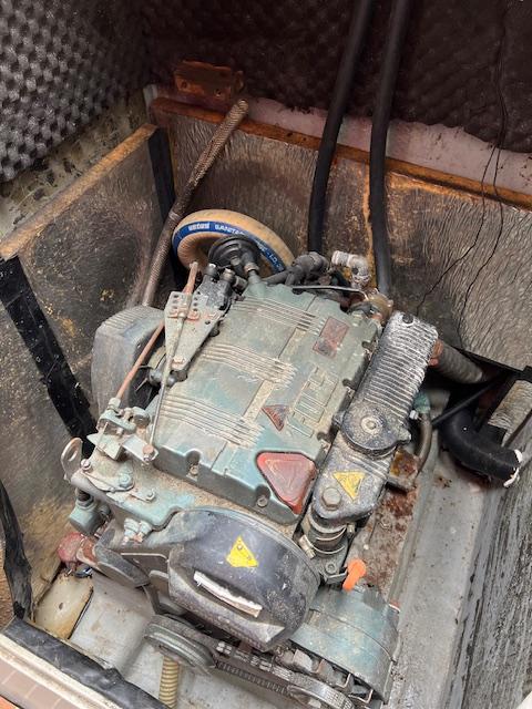 Engine compartment of a 2003 Custom 38 C/R boat with visible wear and components.