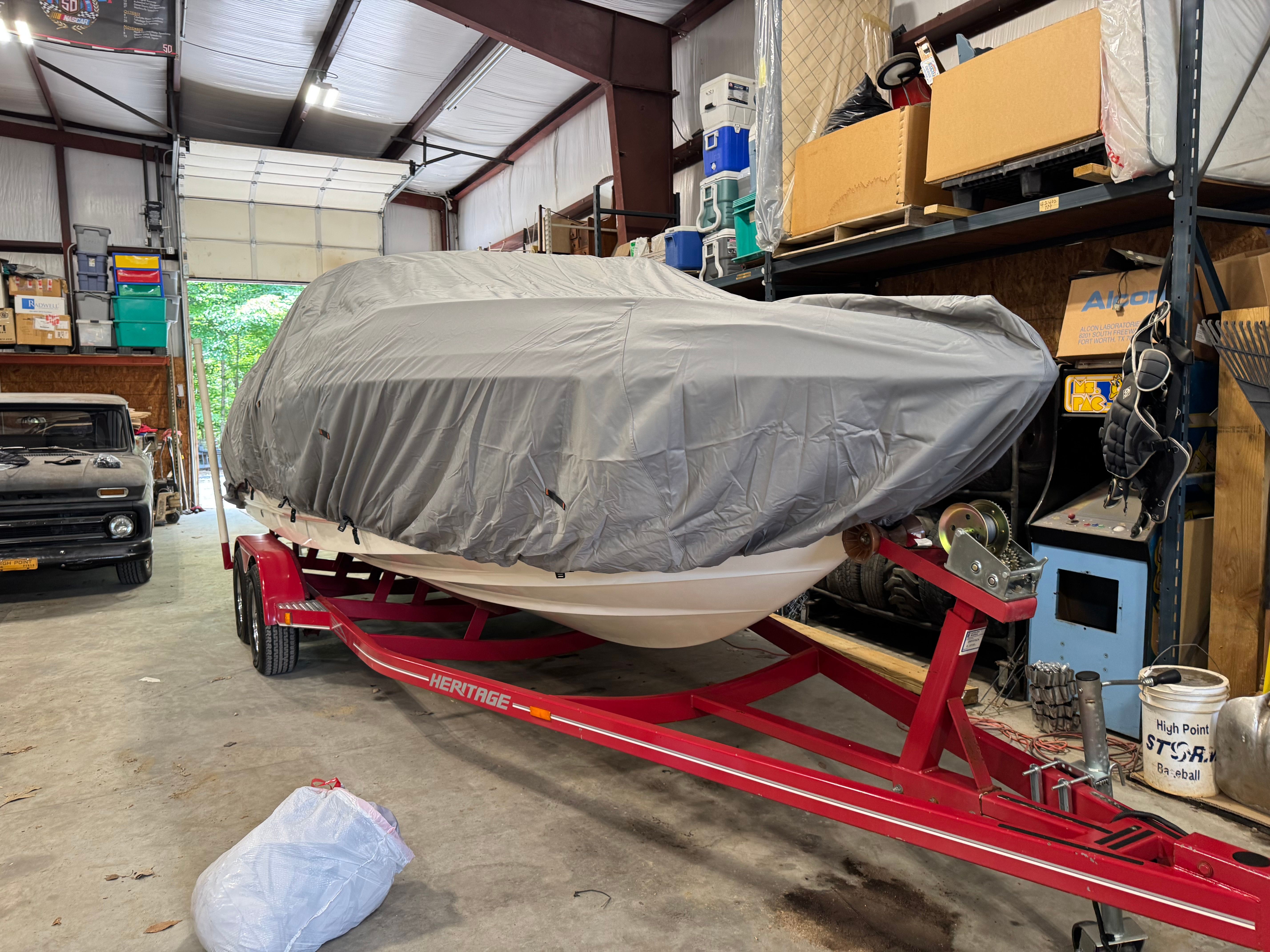 2000 Chaparral 230 SSi boat on trailer in garage.