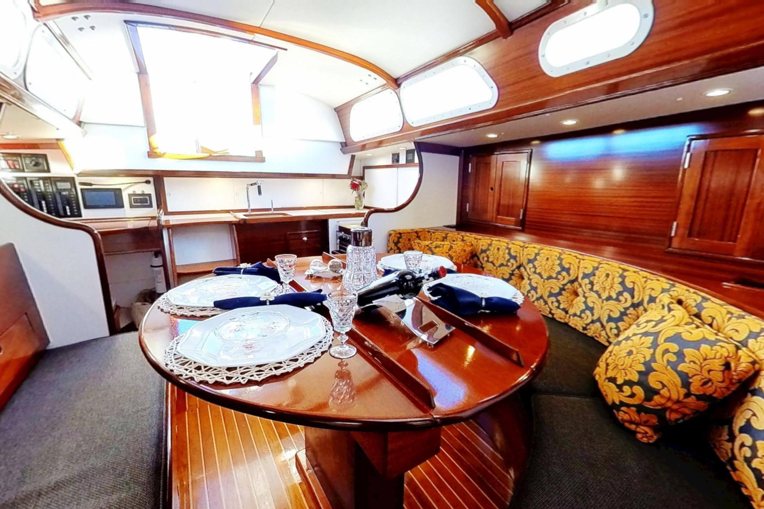 Luxurious 1970 Hinckley Bermuda 40 yacht interior with elegant dining area and plush seating.