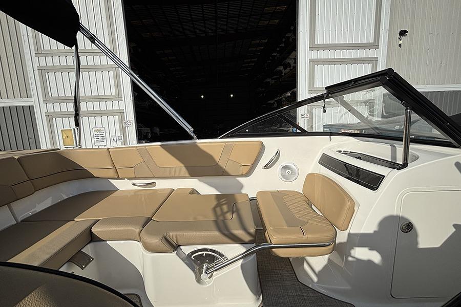 2023 Bayliner VR5 Bowrider OB interior with tan seating and open storage area.