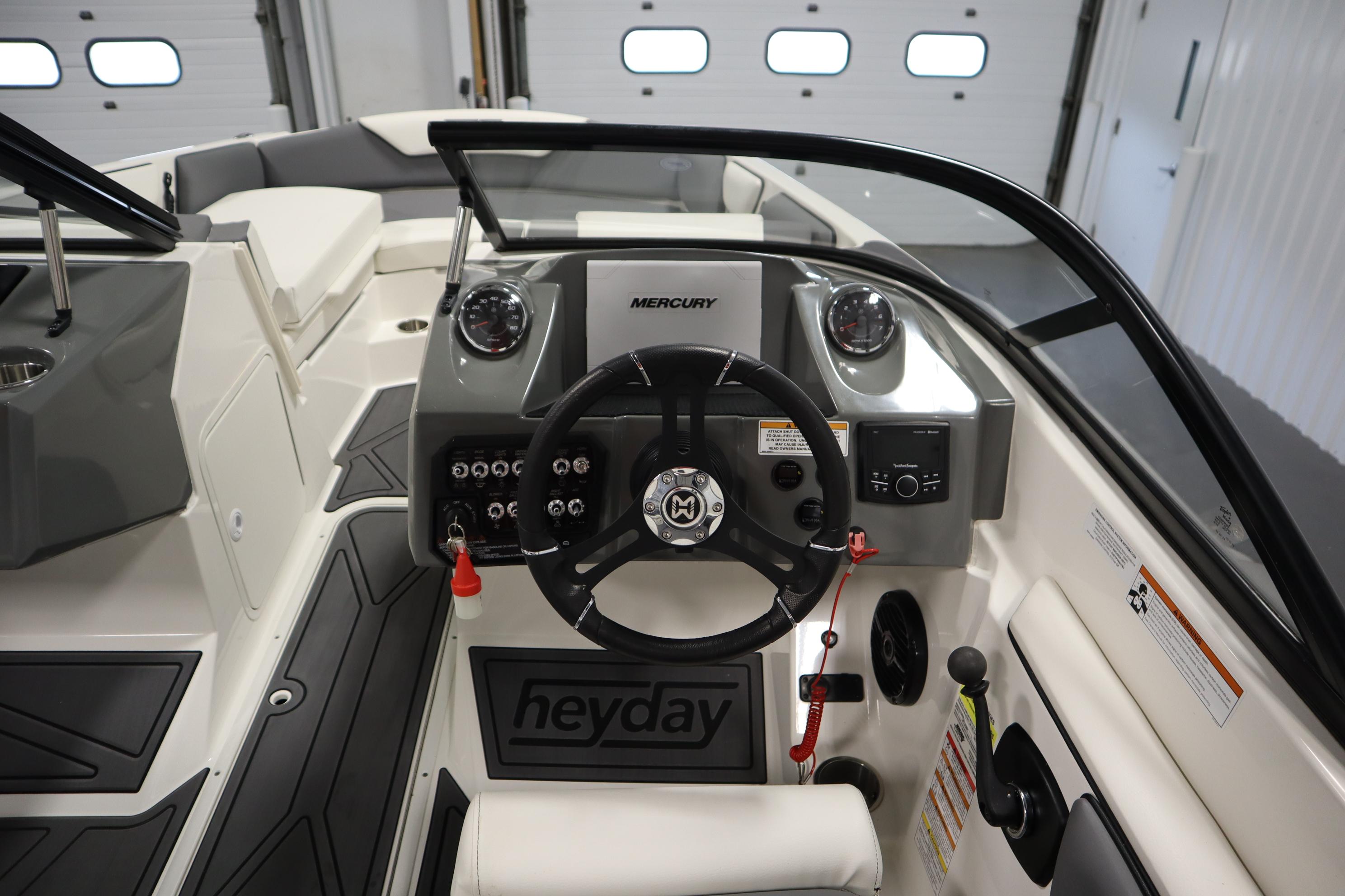 2023 Heyday WT Surf boat interior with steering wheel and dashboard controls.