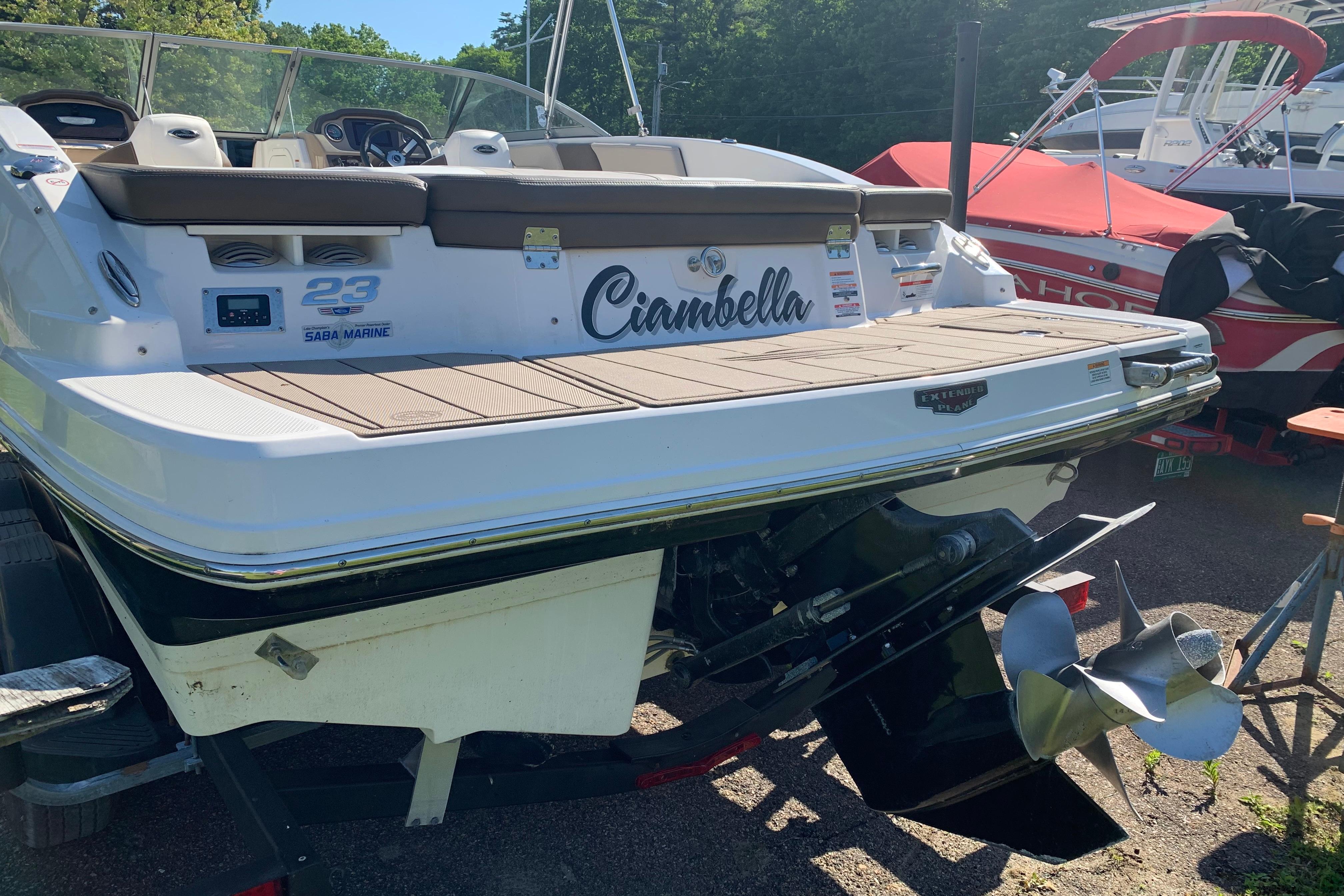 2022 Chaparral 23 SSi boat, rear view with propeller, parked outdoors.