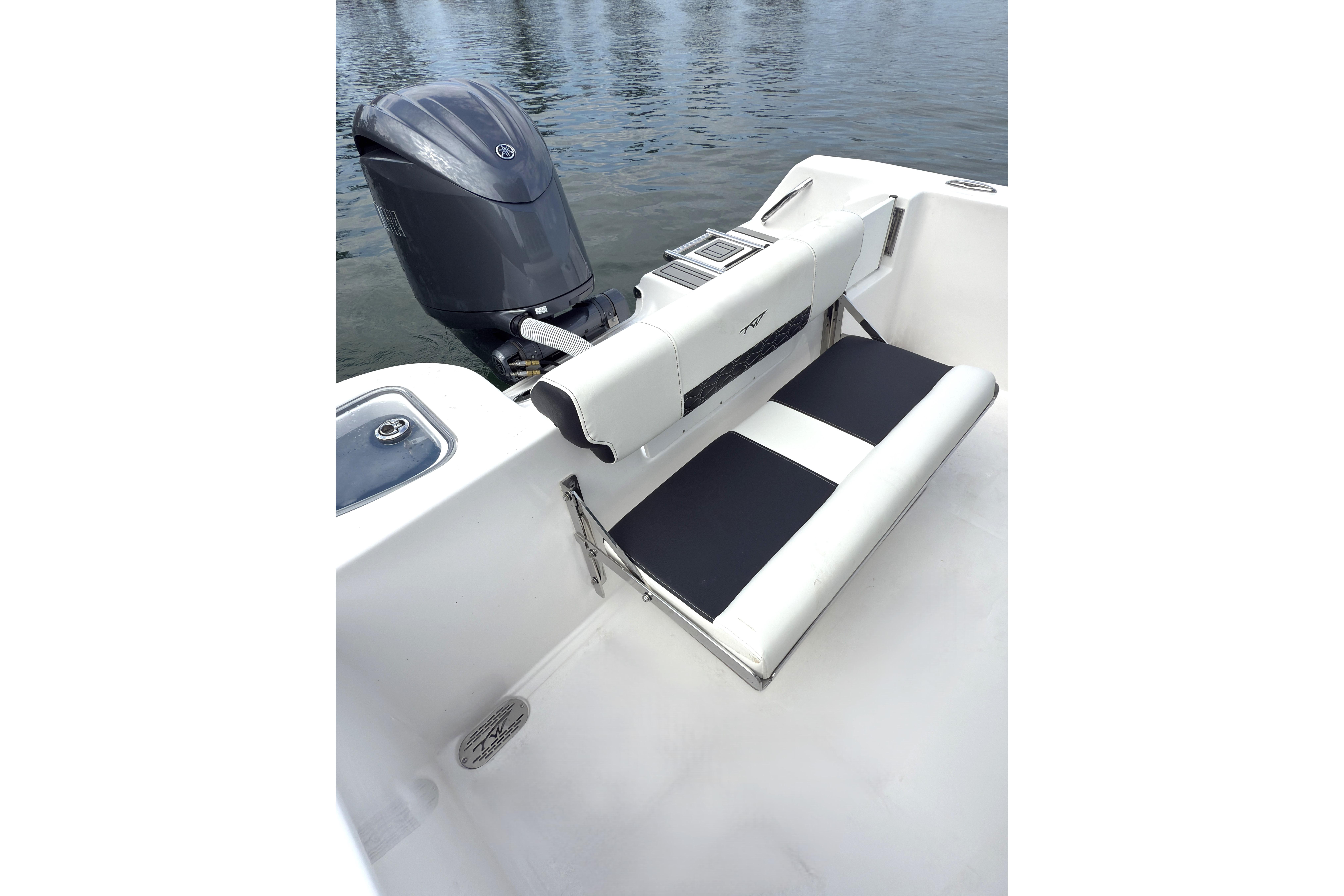 2026 Tidewater 210 CC Adventure boat with outboard motor and seating, on calm water.