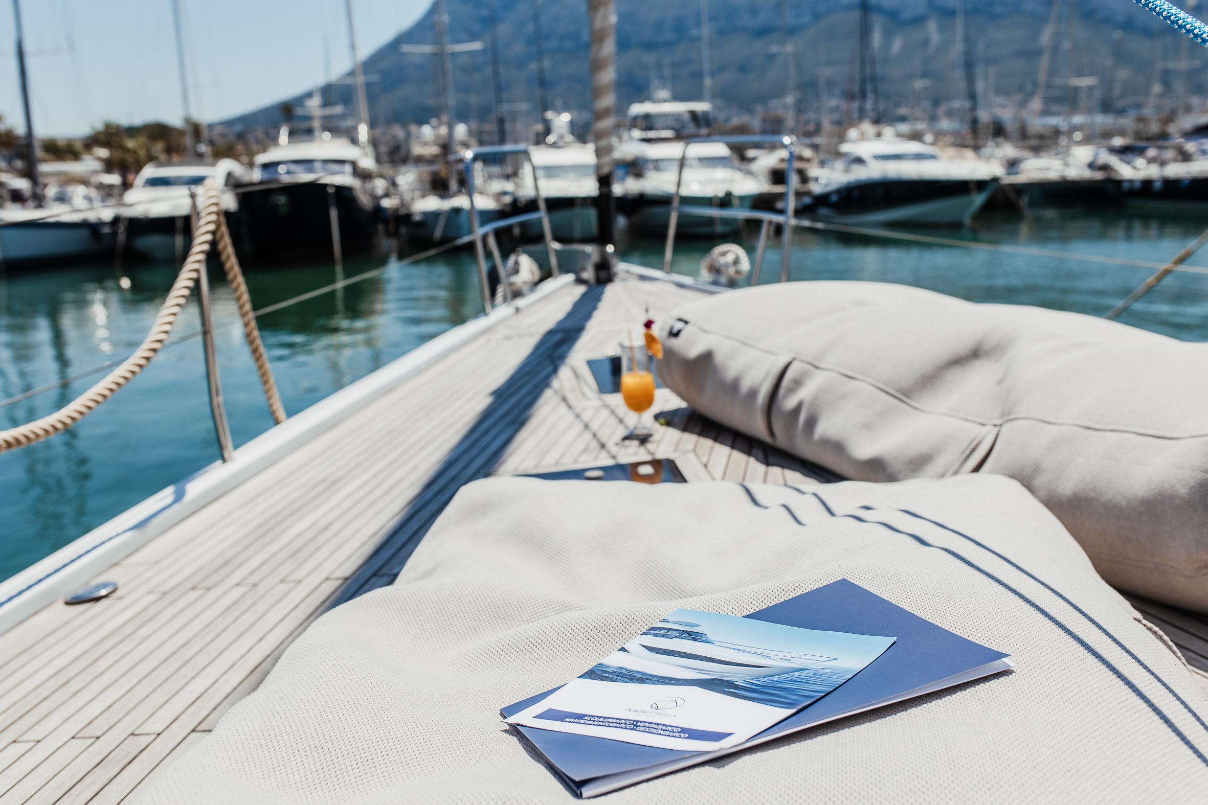 Luxury Hanse 630e yacht deck with cushions, marina view, 2008 model.