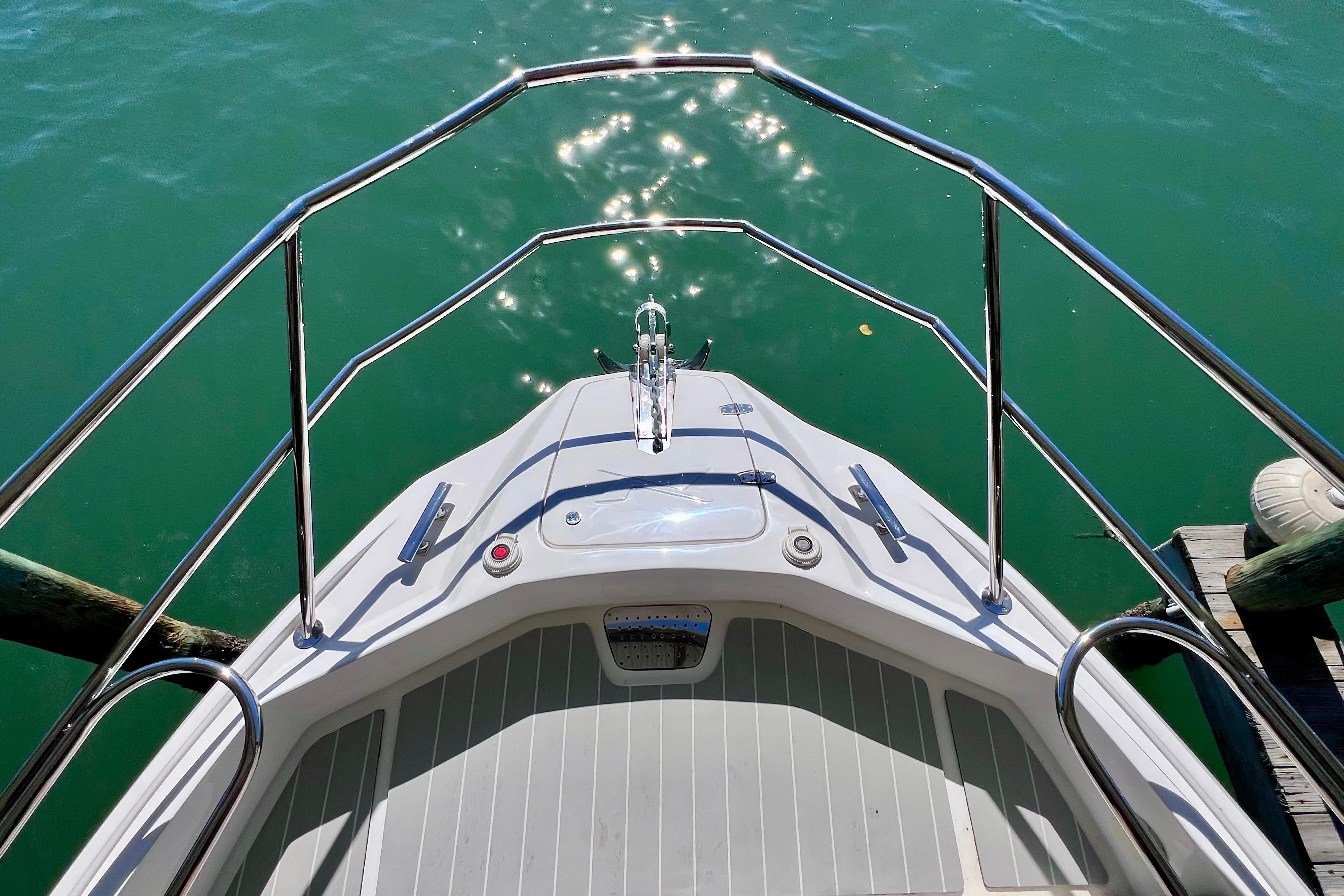 Bow view of 2024 NX Boats 370 HT on calm water.