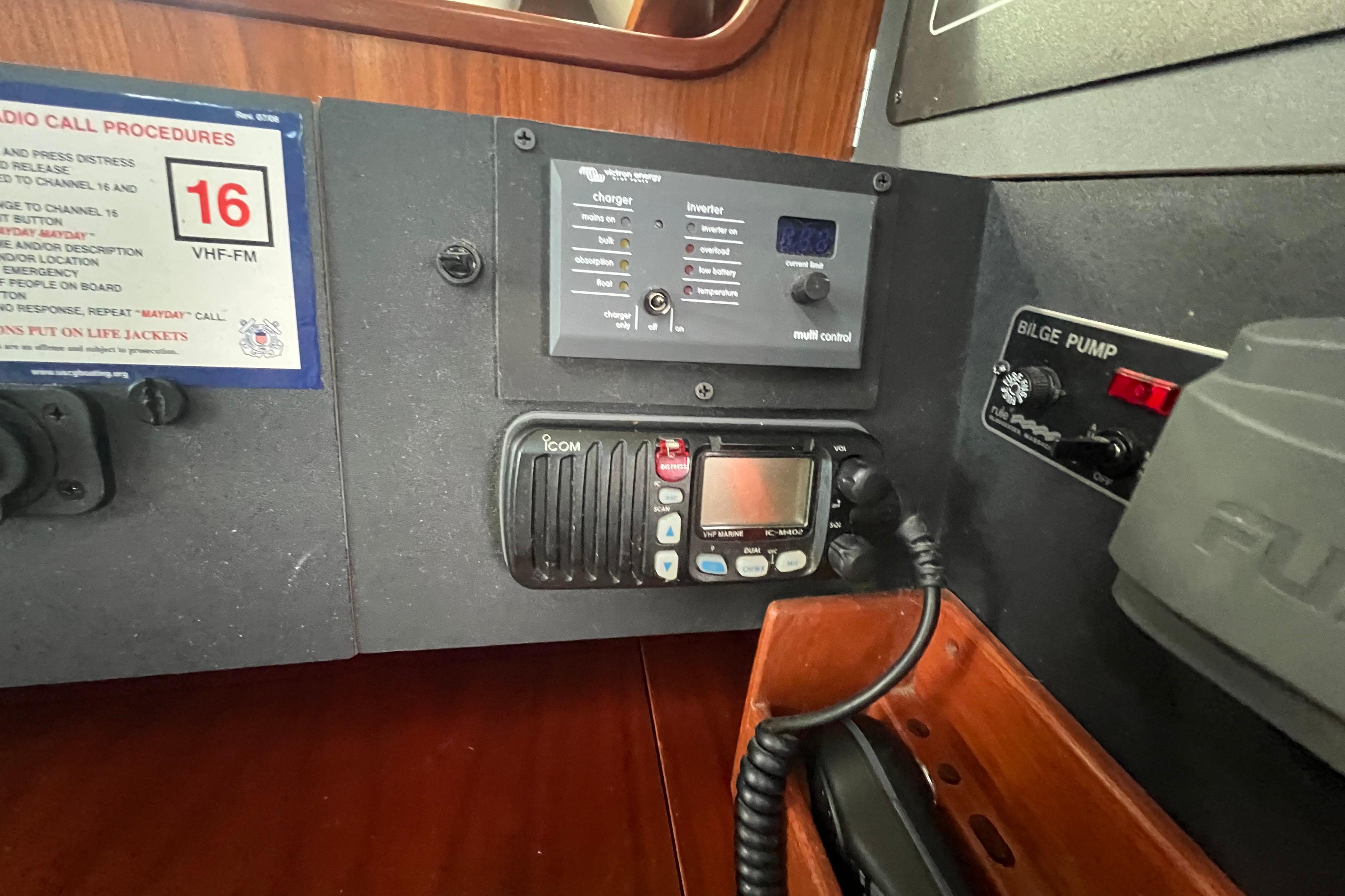 Control panel of a 1994 Beneteau Oceanis 351 sailboat with radio and bilge pump.