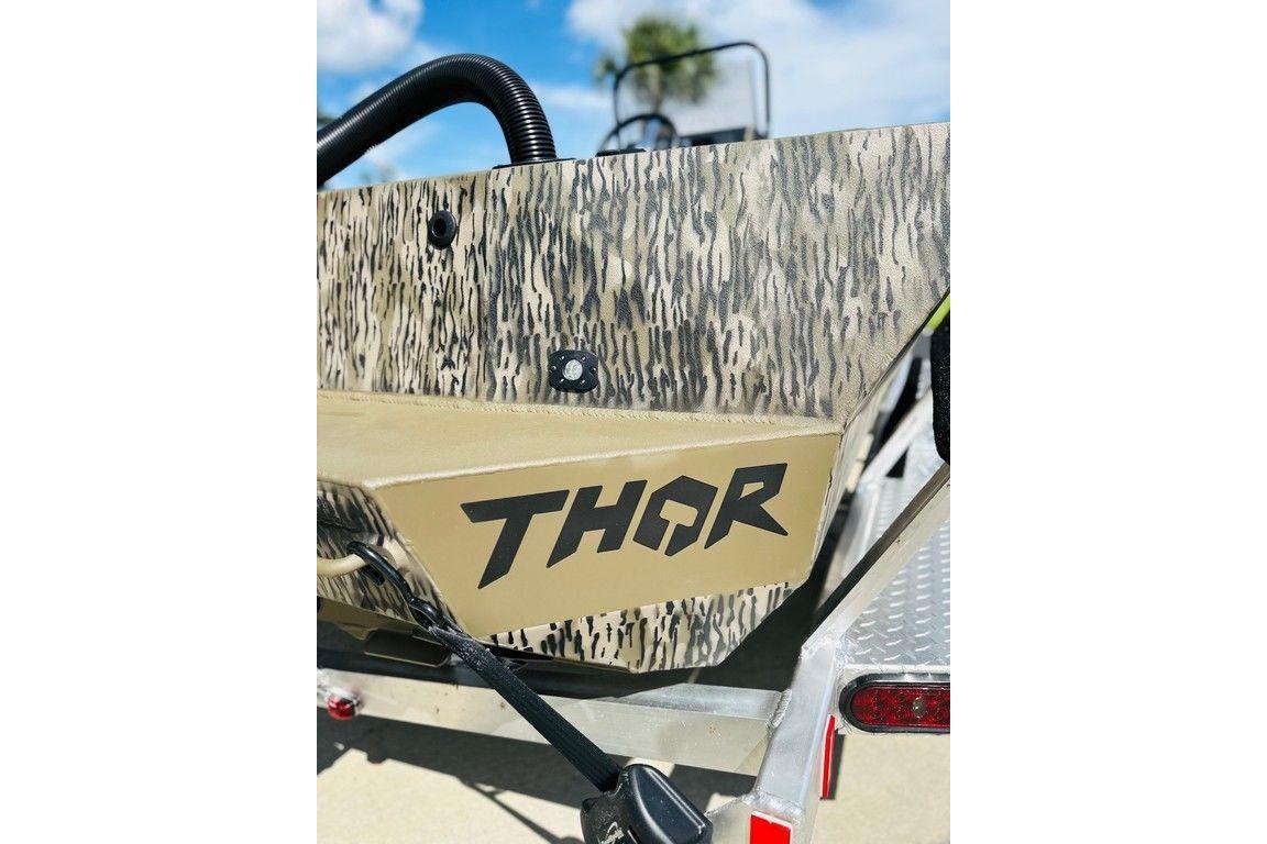2026 Thor 1900 boat with camouflage design and bold logo.